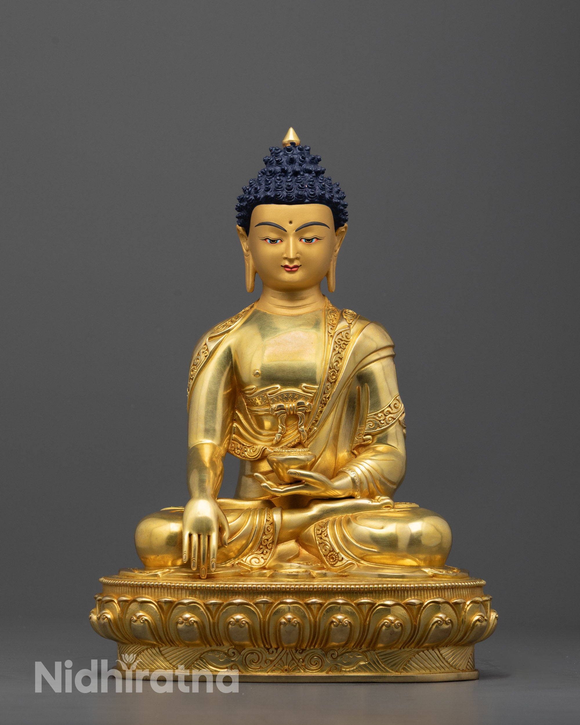 Front view of Buddha Shakyamuni statue with 24K gold-gilded face and detailed lotus throne