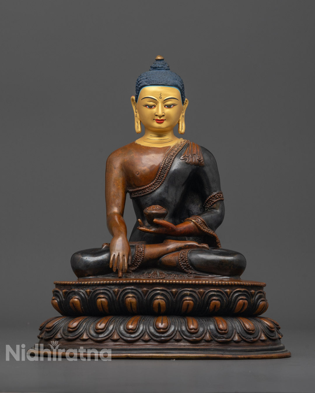 Front view of Buddha Shakyamuni statue with 24K gold-gilded face and oxidized copper body