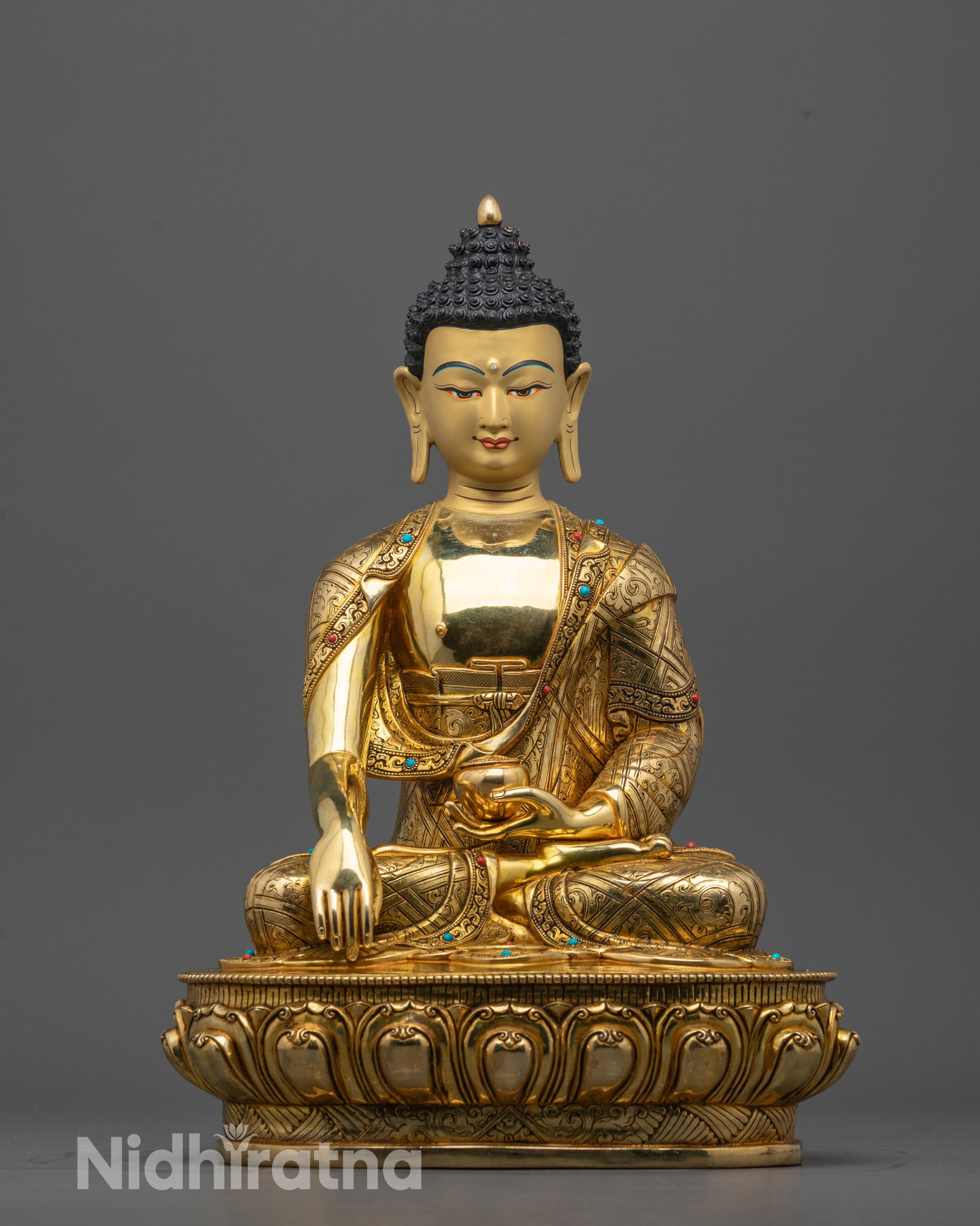 Front view of Buddha Shakyamuni statue with gold-gilded face and lotus throne from Nepal