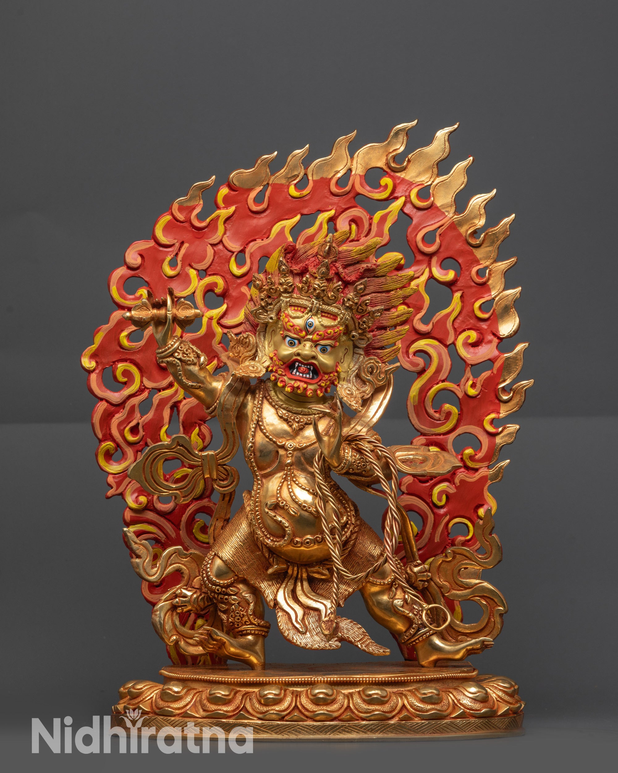 Nepalese handmade Vajrapani statue, gold gilded with intricate fire backdrop and wrathful expression