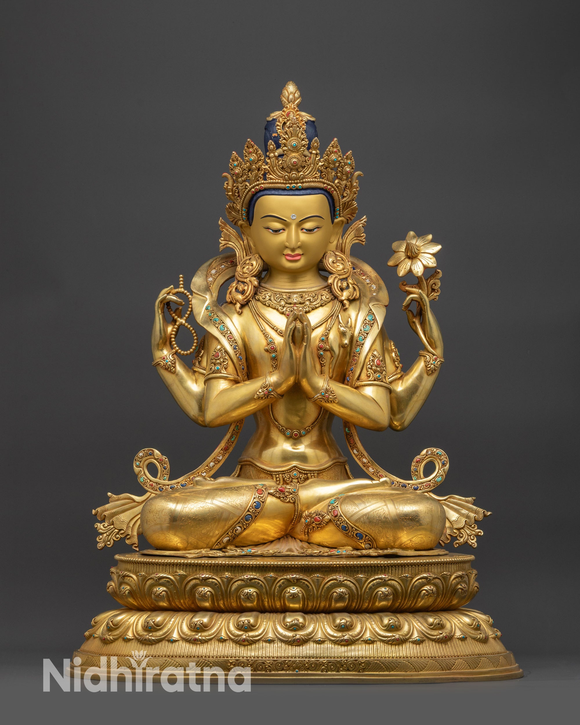Front view of Chenrezig Statue showing four-armed Bodhisattva on lotus base
