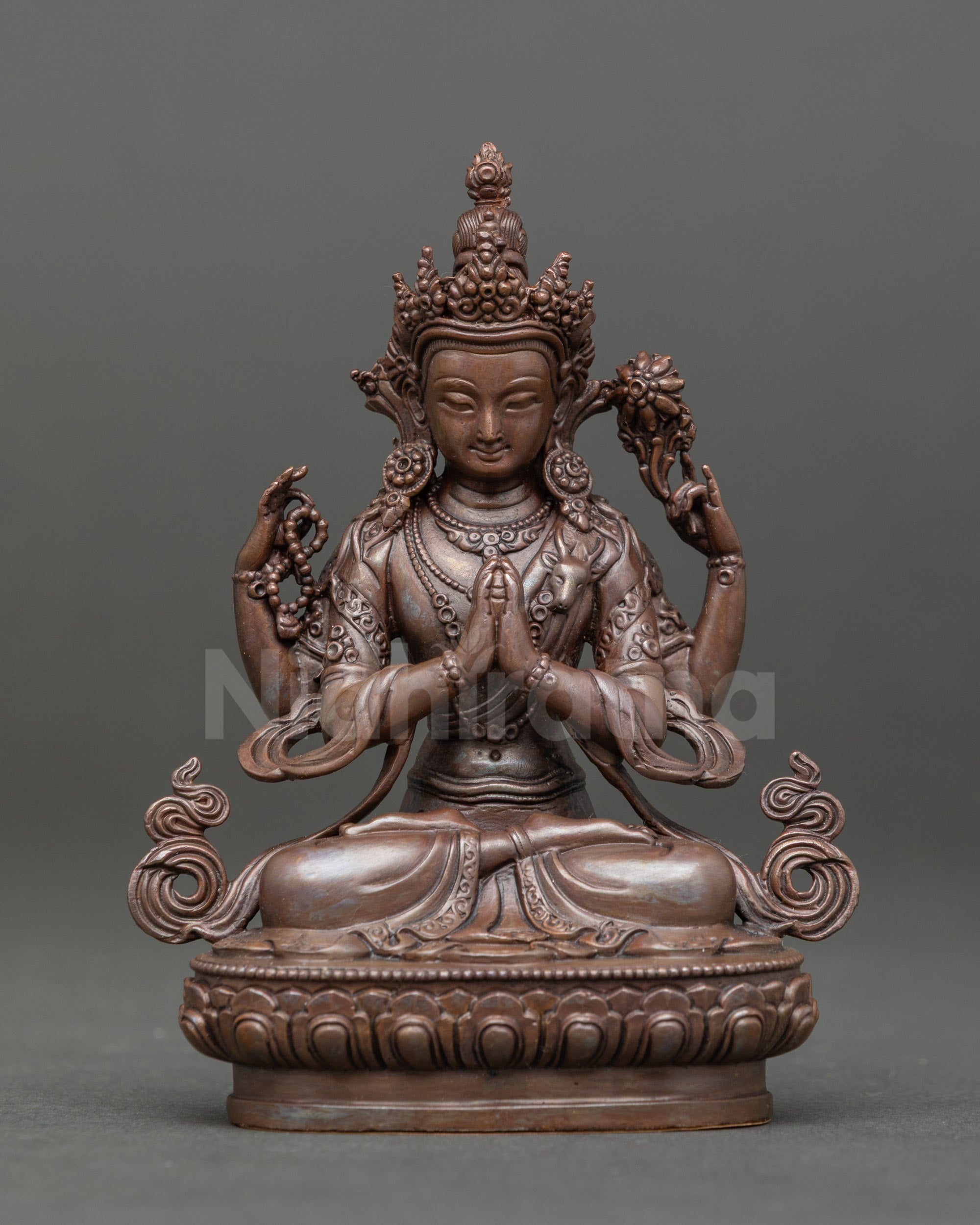 Front view of Chenrezig statue holding crystal rosary and lotus, seated on lotus pedestal