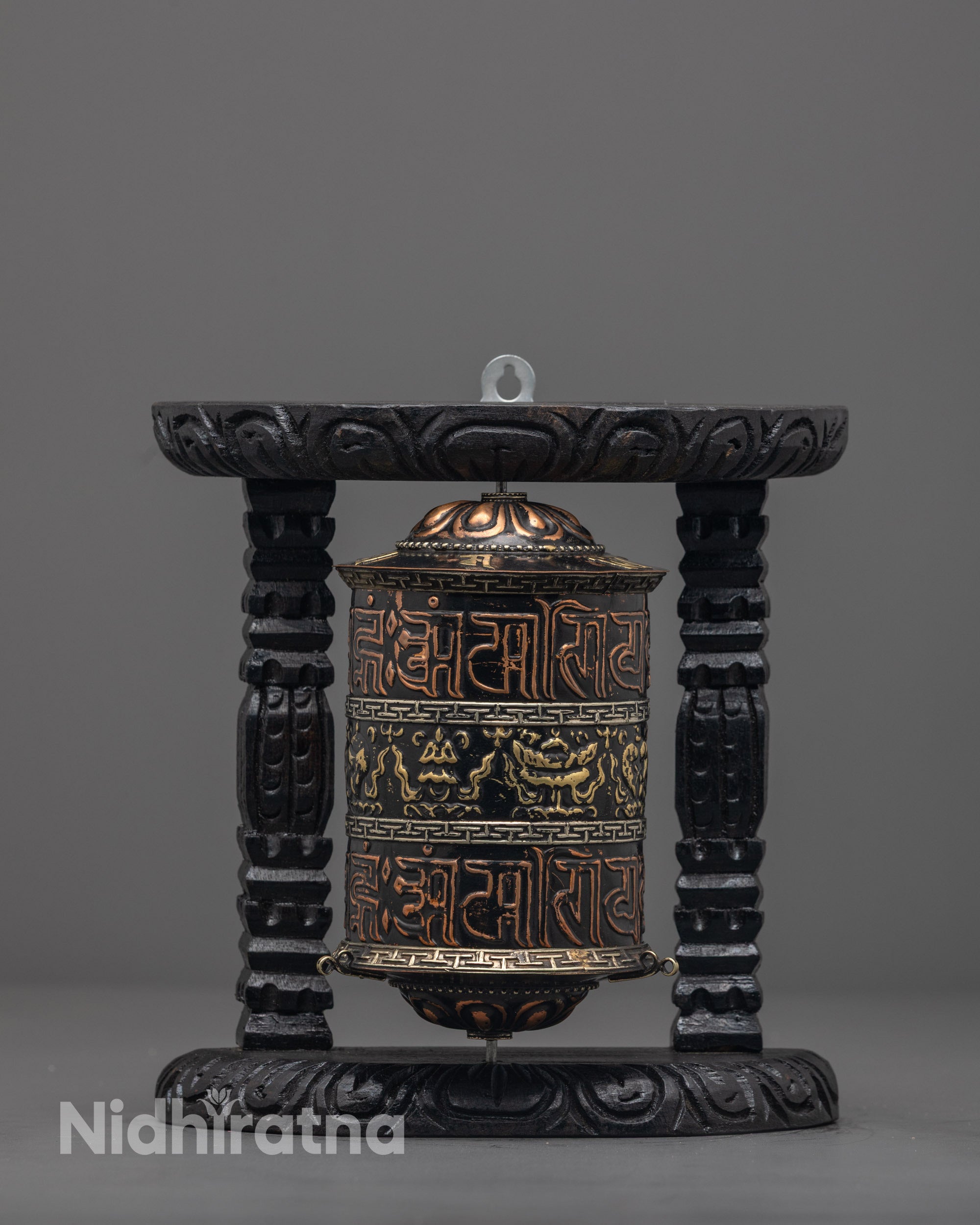 Front view of Decorative Buddhist Prayer Wheel with carved copper and brass finish