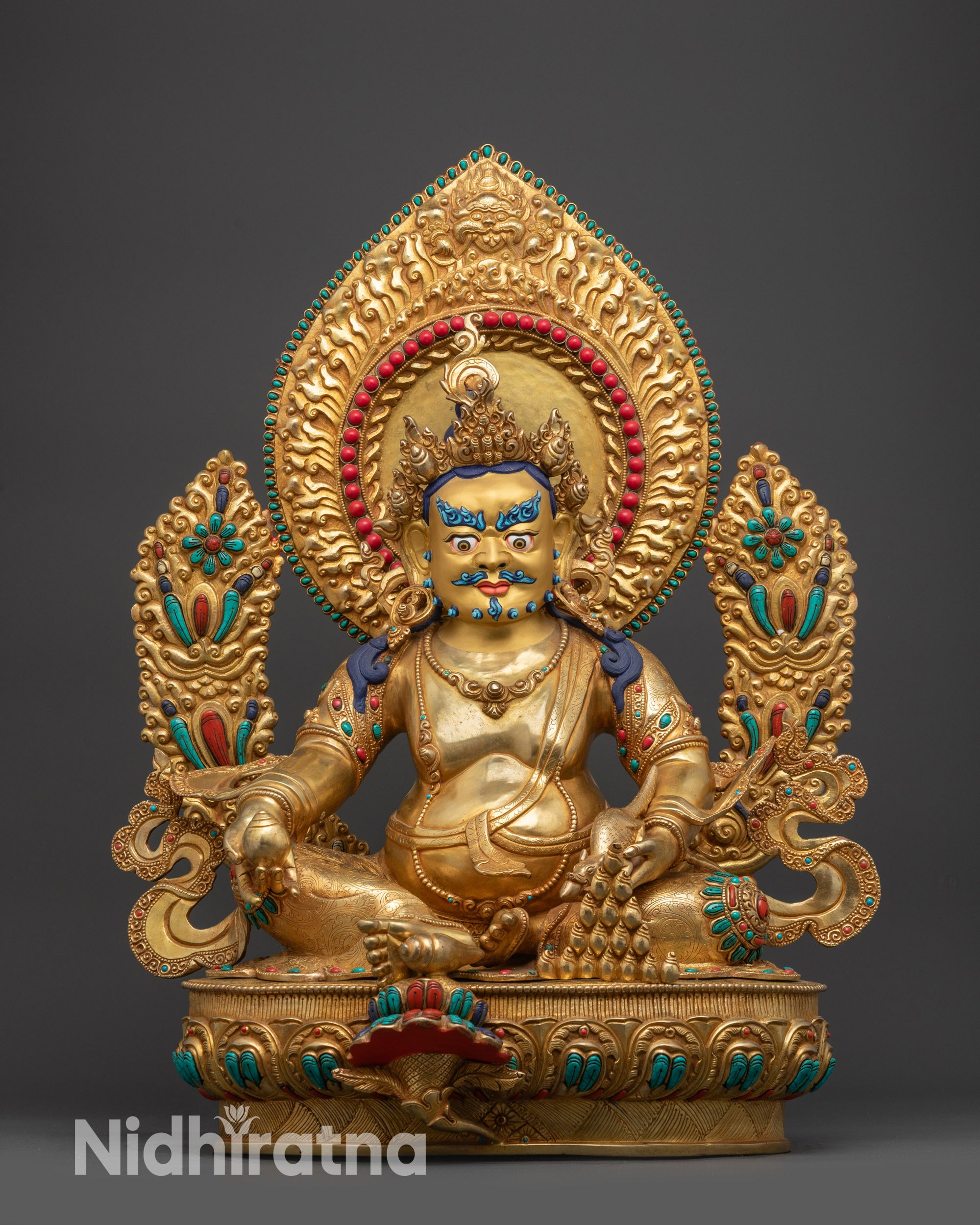 Front view of Divine Dzambhala Sculpture with gold-gilded face and lotus seat

