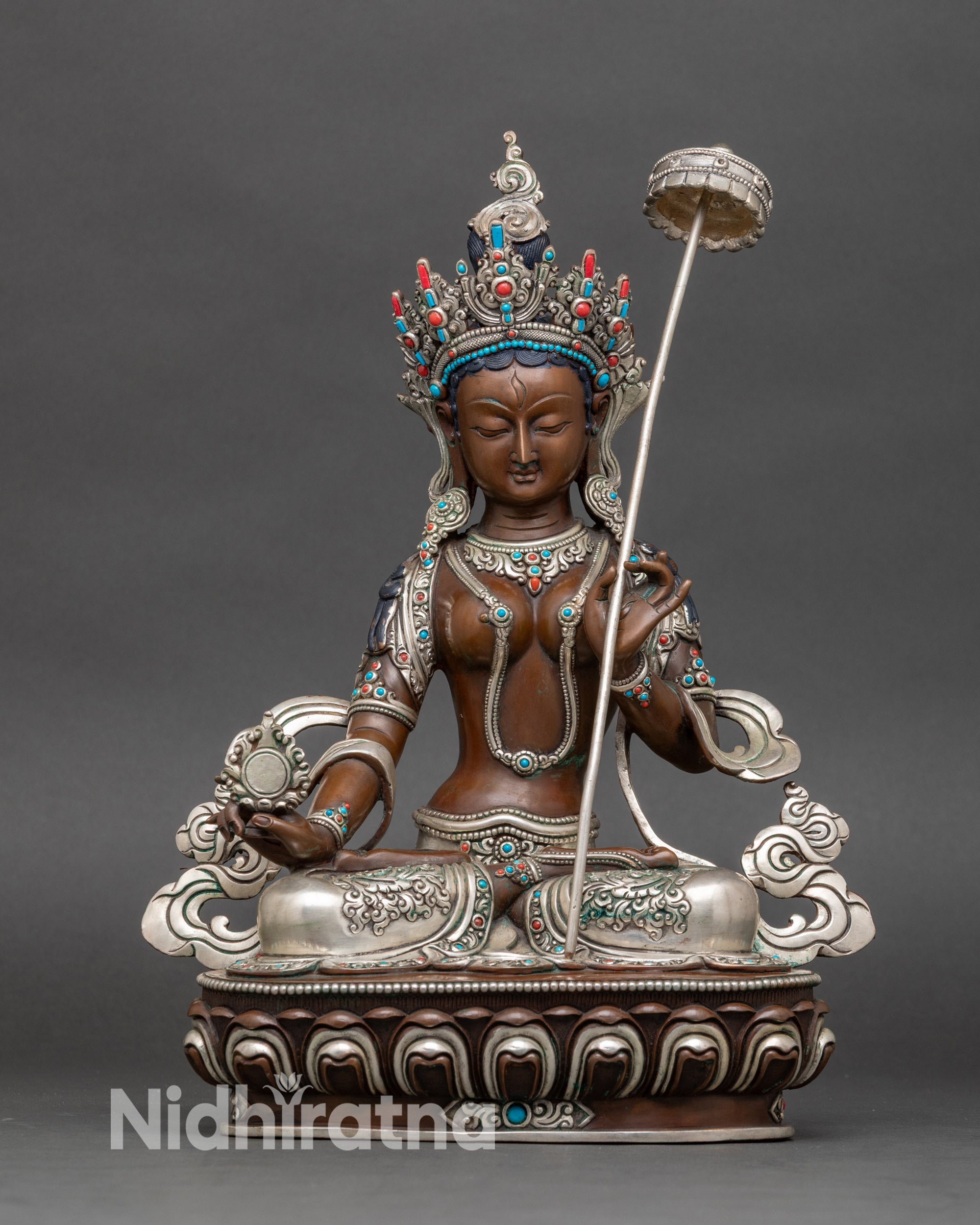 Front view of Dukar Sitatapatra statue, handcrafted copper with silver-plated accents