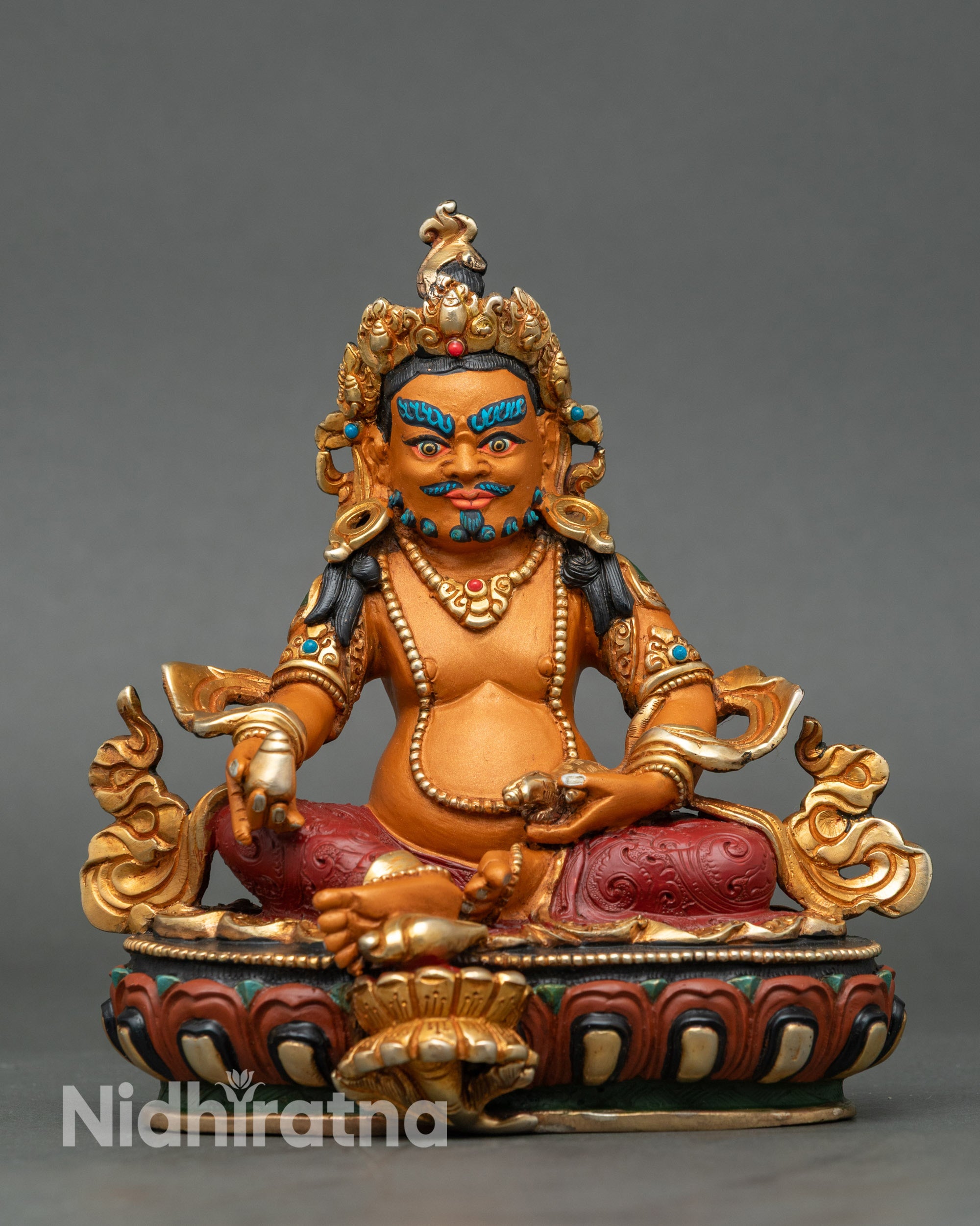 Front view of Dzambhala Statue seated on lotus with citrion fruit and mongoose