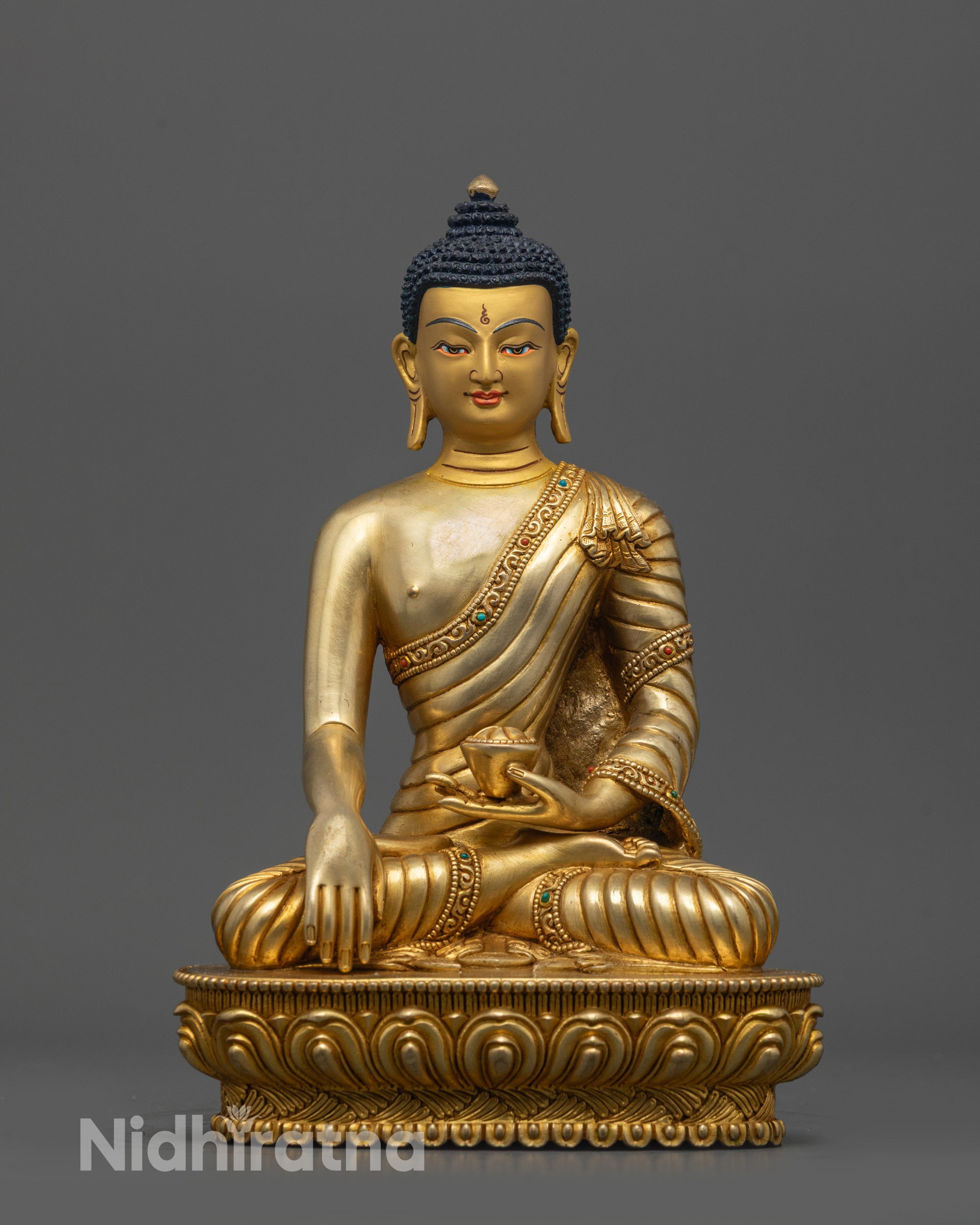 Front view of Enlightened Shakyamuni Buddha Statue with gold-gilded face on copper base
