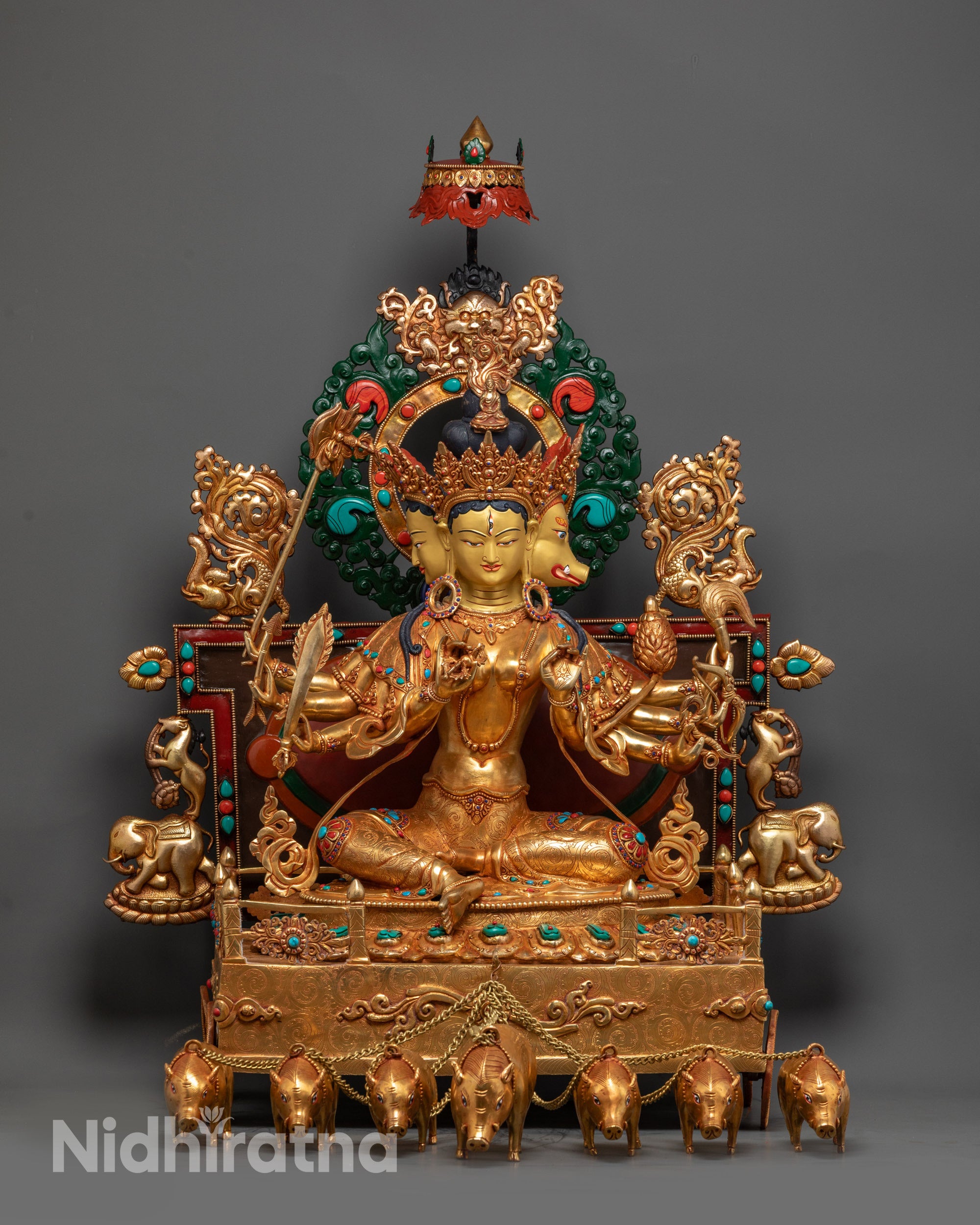 Front view of Goddess Marichi Statue with three gold faces and radiant fire-gilded body