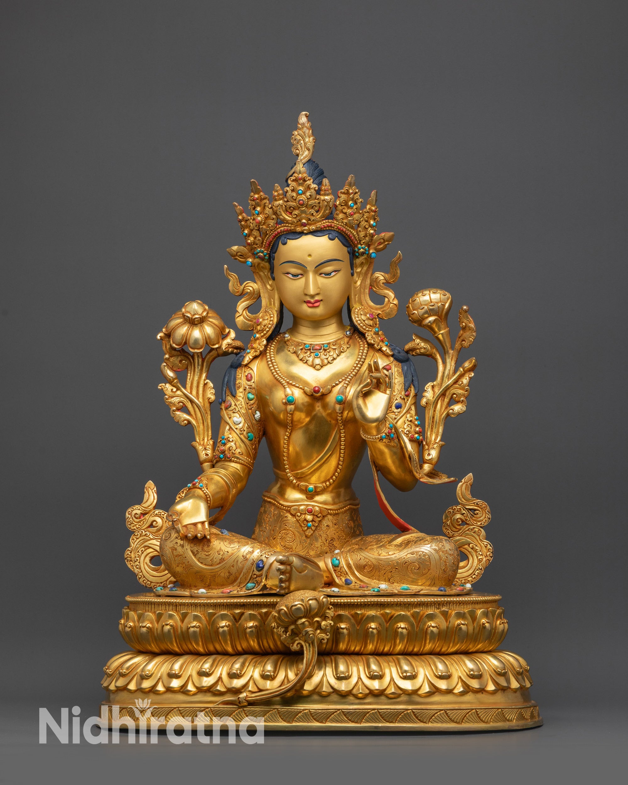 Front view of Green Tara Statue on double-layered lotus seat holding utpala flower in hand