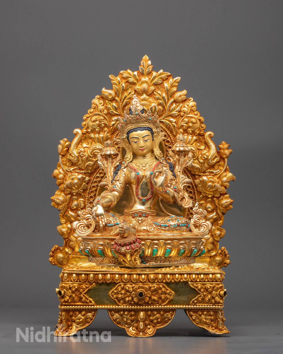 Front view of Green Tara sculpture with 24k gold face and lotus throne details