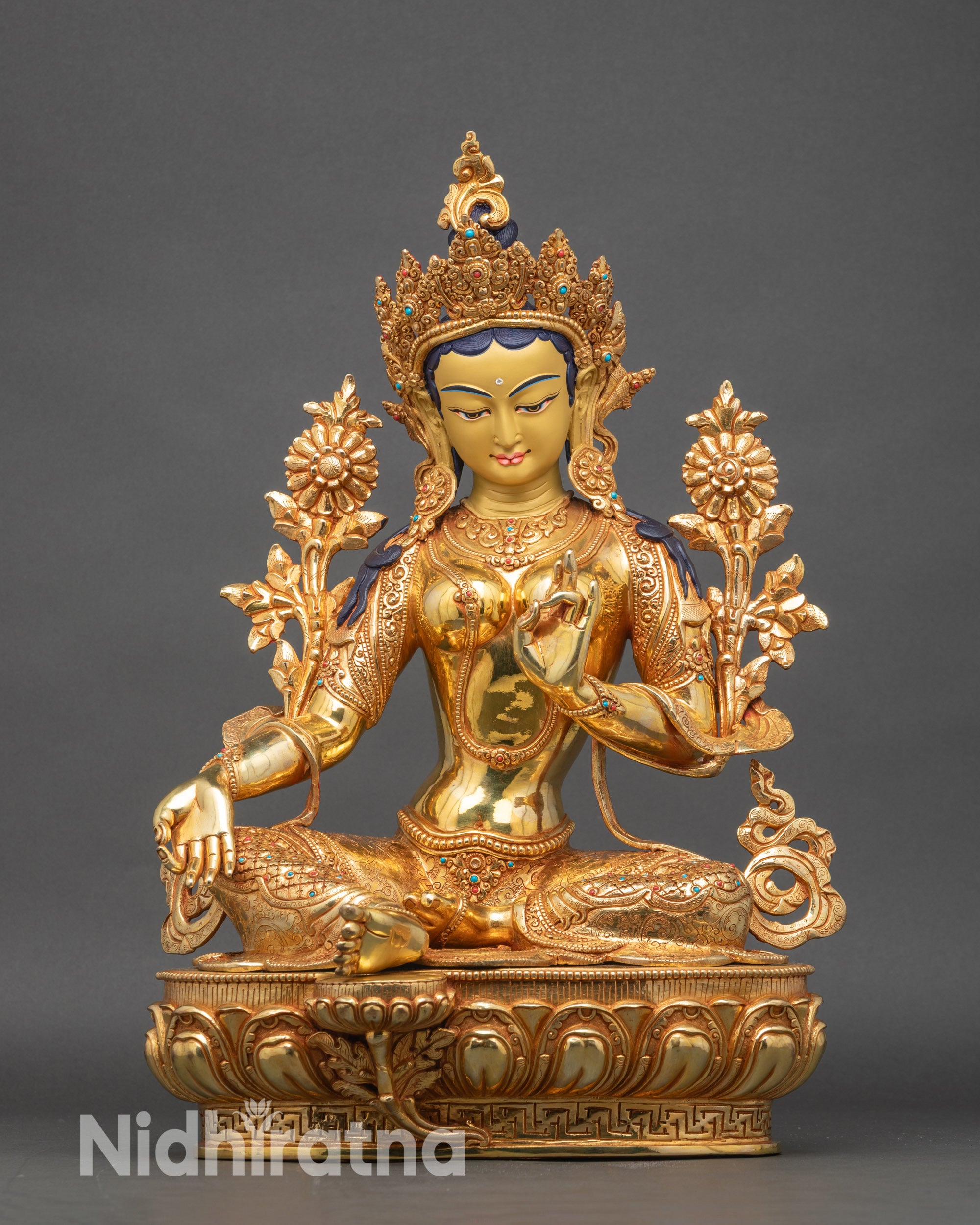 Front view of Green Tara statue showcasing gold fire-gilded copper and lotus pedestal