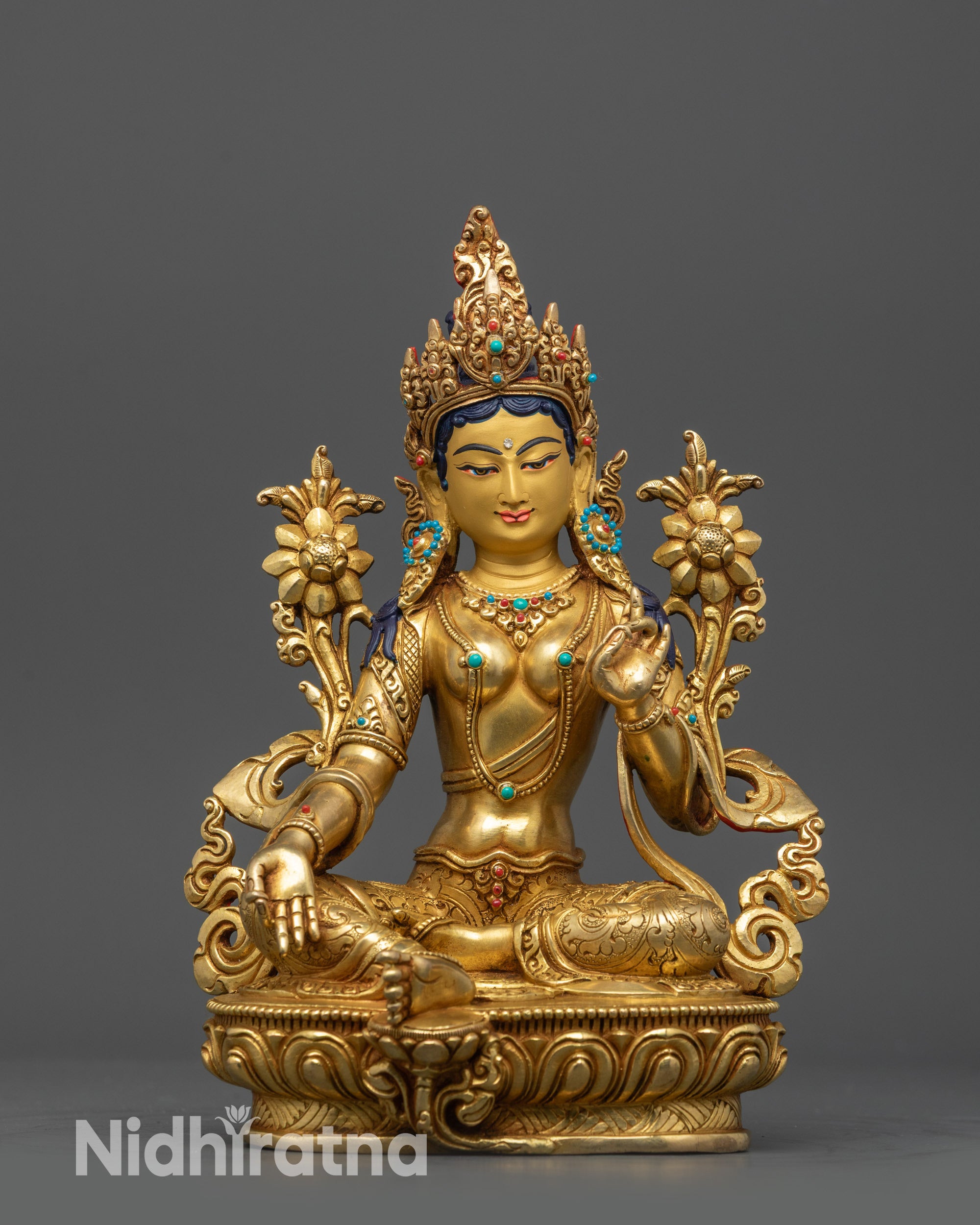 Front view of Green Tara statue with utpala flower and Vitarka mudra