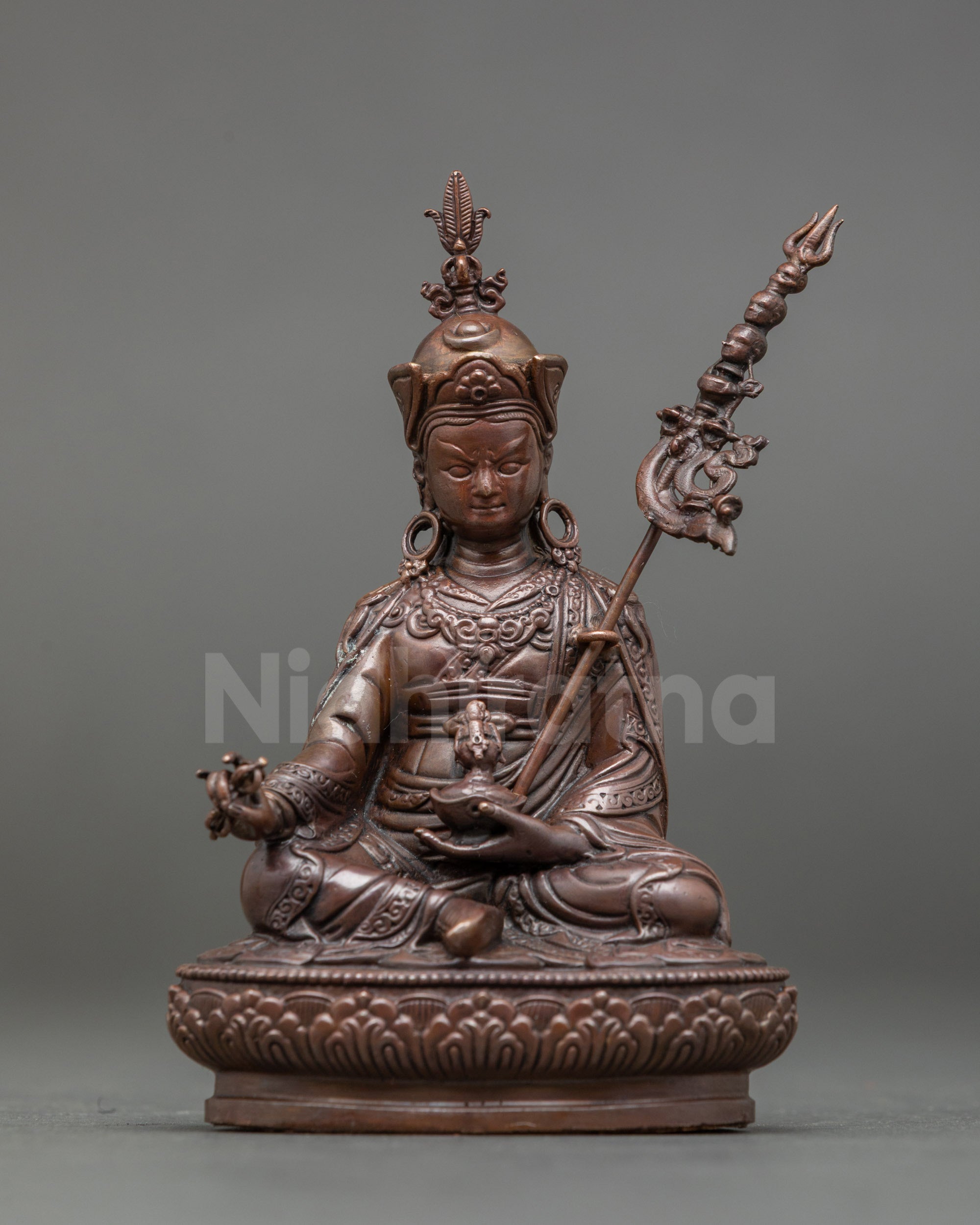 Front view of Guru Padmasambhava Statue seated on a lotus pedestal holding vajra, kapala, and khatvanga