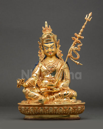 Front view of Guru Rinpoche Statue showing vajra skull cup and khatvanga staff