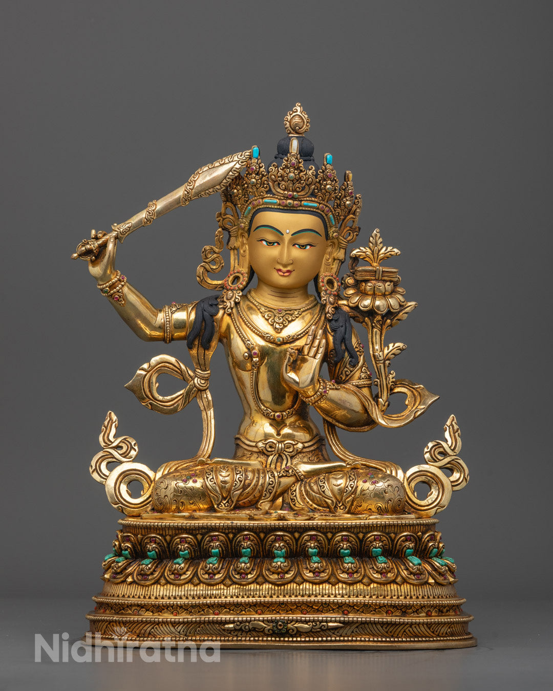Front view of Handcrafted Tibetan Manjushri Sculpture with gold-gilded face and lotus throne