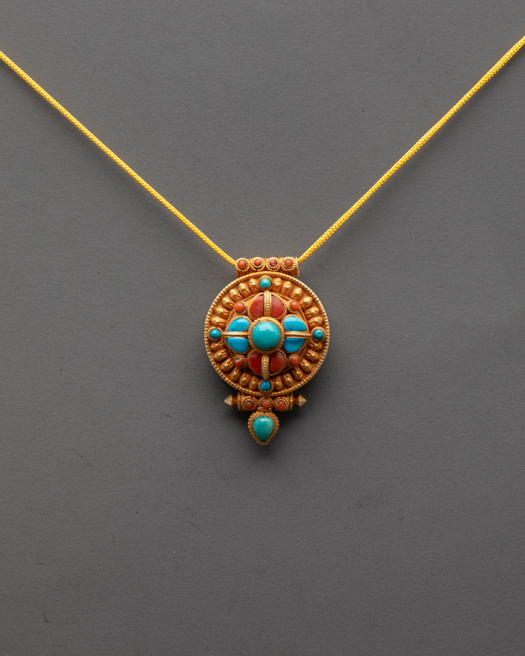 Front view of Handmade Buddhist Amulet Locket with 24k gold gilding and vibrant stones
