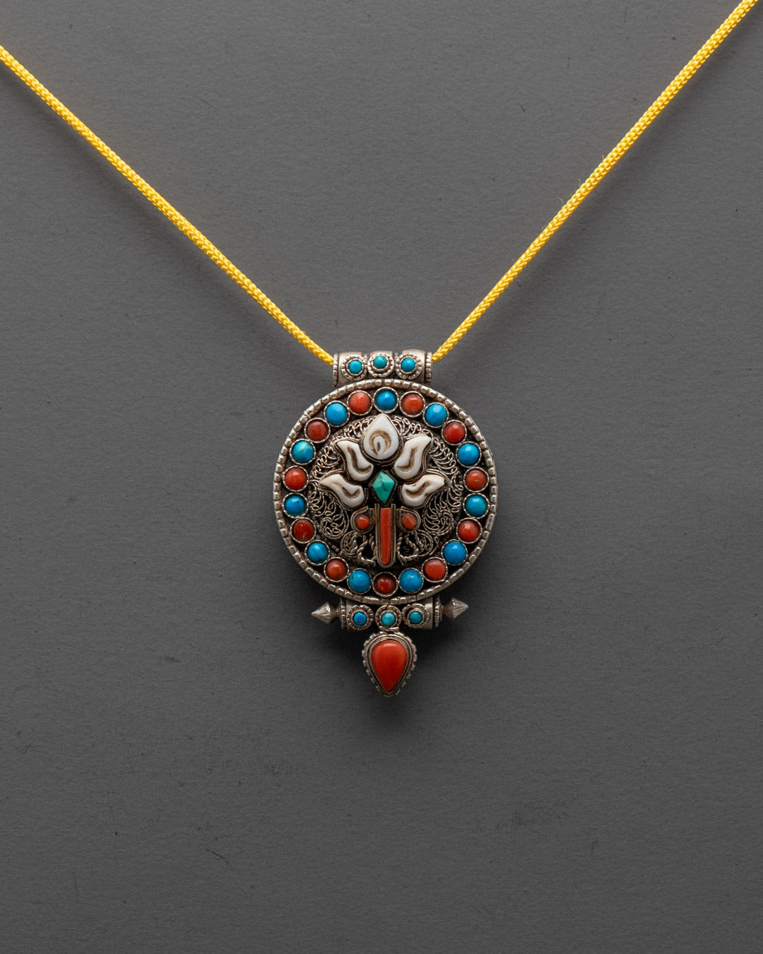 Front view of Handmade Lotus Locket with lotus design and semi-precious stones
