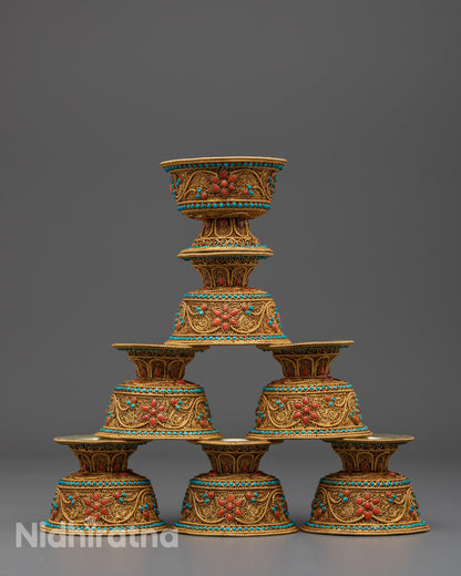Front view of Himalayan water offering bowl with gold filigree and gemstone inlay