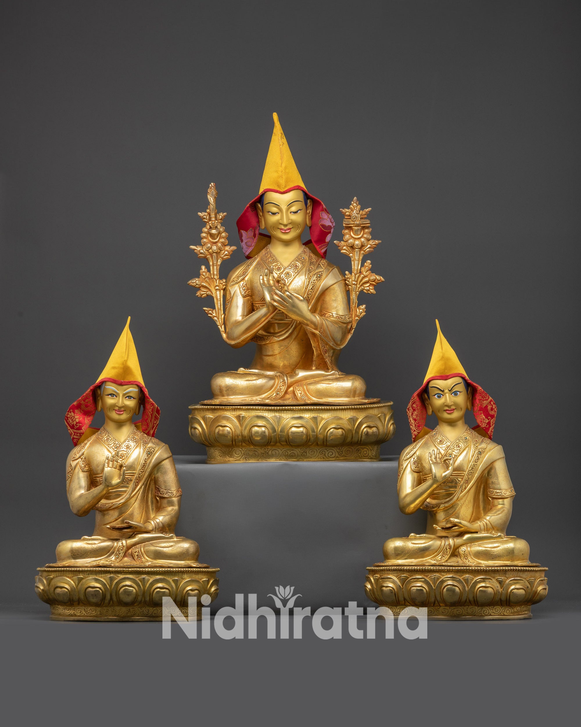 Front view of Je Tsongkhapa with disciples Gyaltsab Je and Khedrup Je, yellow Pandita hats, gold-gilded faces, and monastic robes.