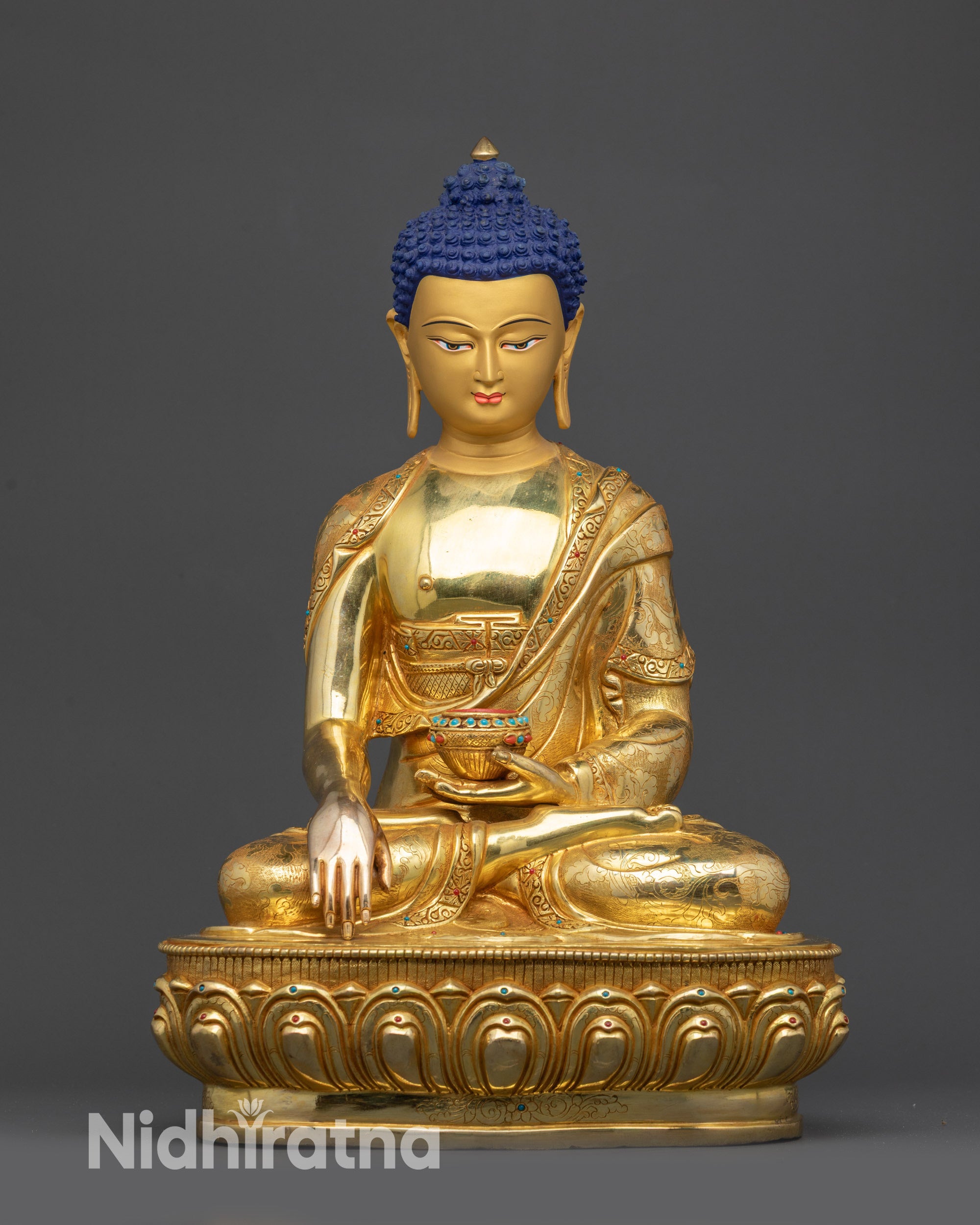 Front view of Lord Gautama Buddha statue with lotus seat and gold-gilded face
