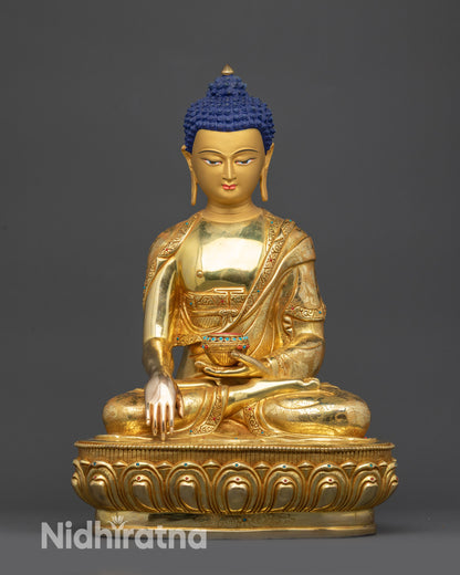 Front view of Lord Gautama Buddha statue with lotus seat and gold-gilded face

