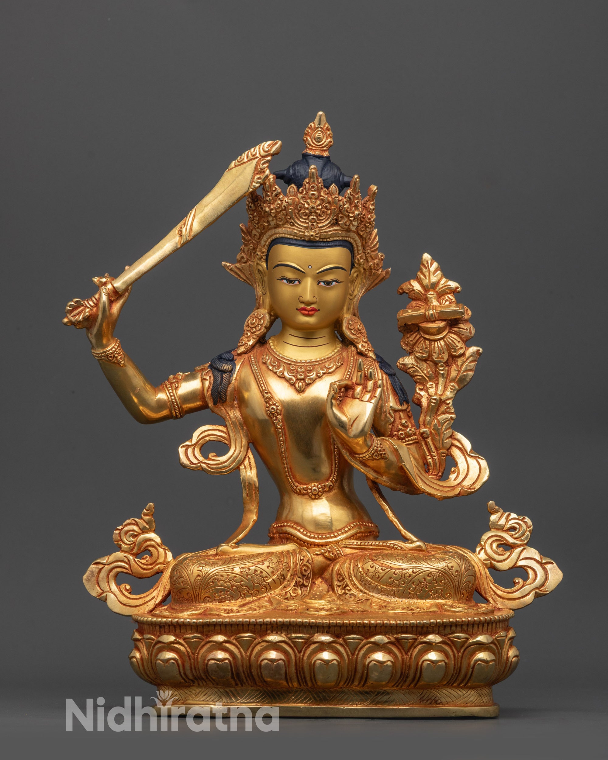 Front view of Manjushri Statue on lotus with flaming sword and Sutra in hand