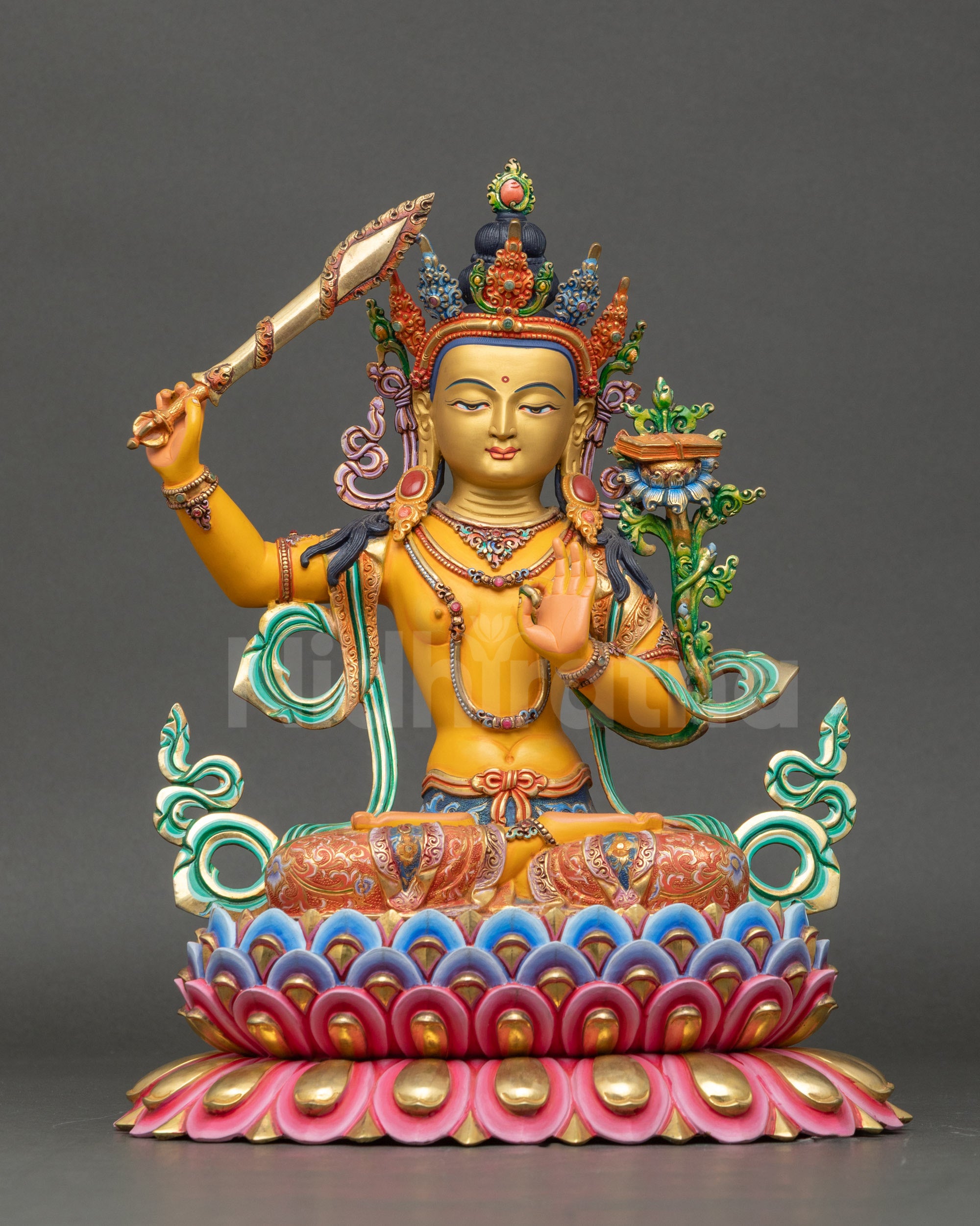 Front view of Manjushri statue, handcrafted Nepalese copper with gold-painted face