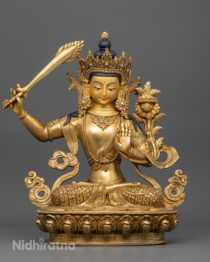 Front view of Manjushri statue on engraved lotus pedestal, gold fire-gilded copper, hand-carved Newari Buddhist sculpture