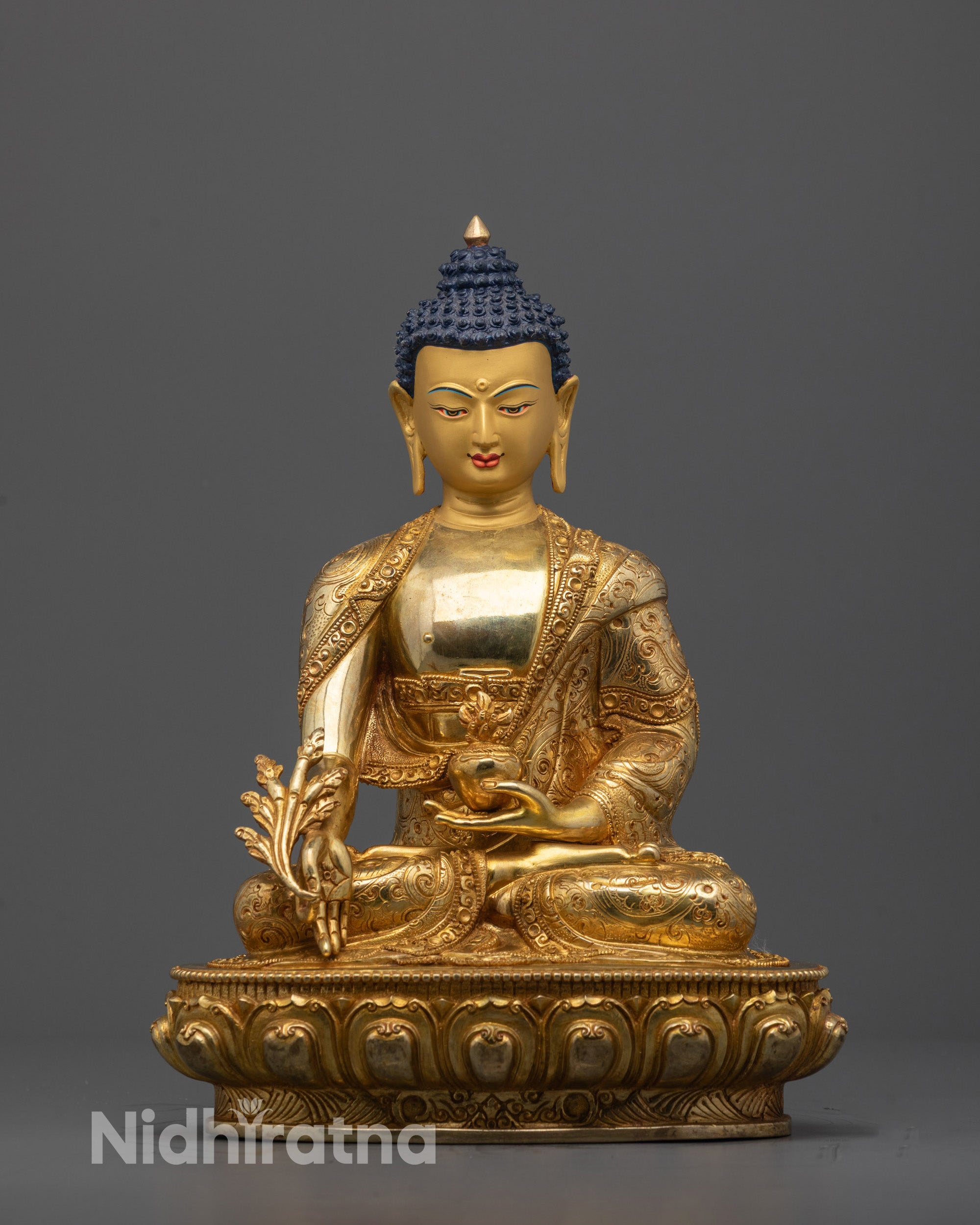 Front view of Medicine Buddha Sculpture with gold-gilded face and healing gesture