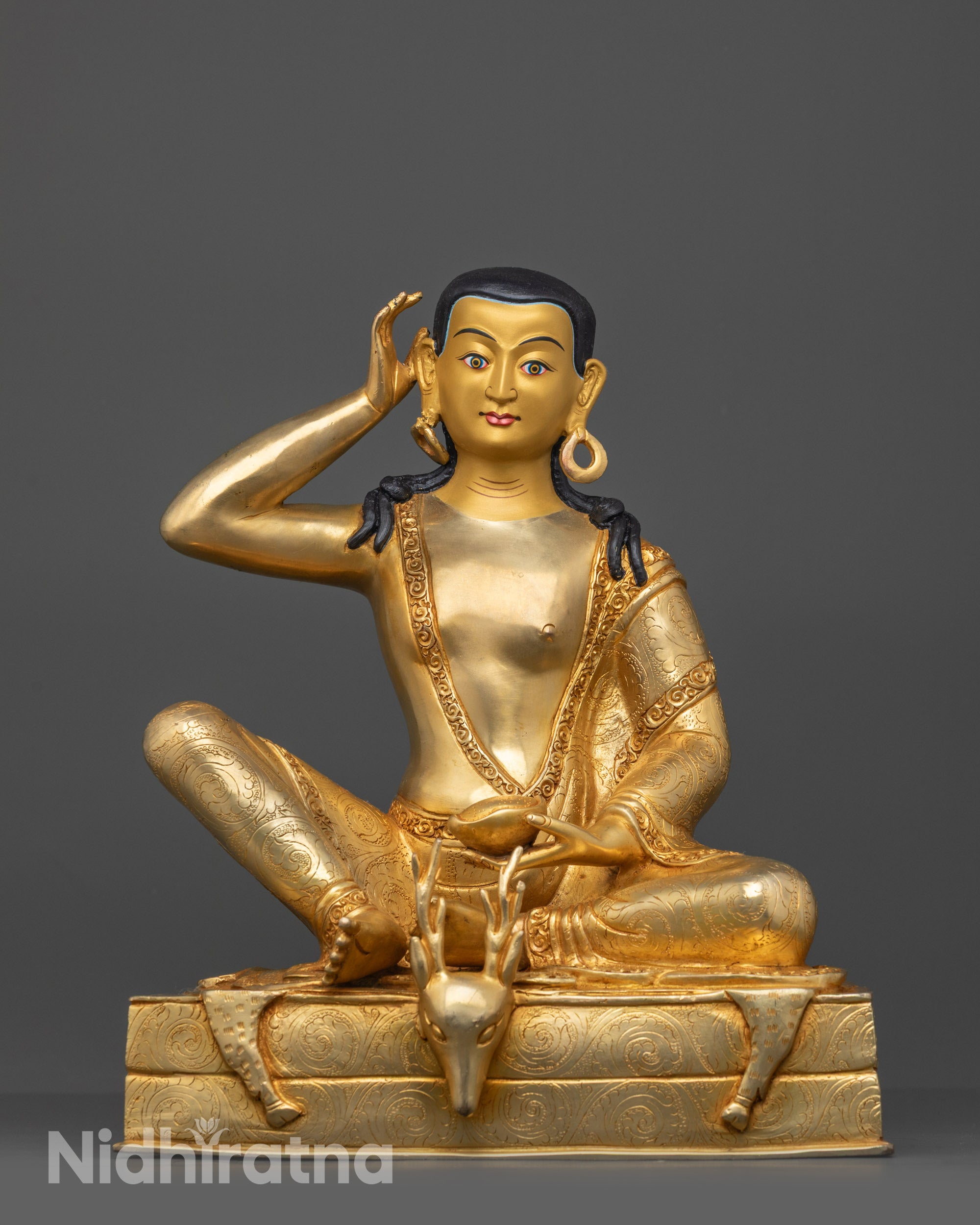 Front view of Milarepa Statue with gold-gilded face and intricate carved robe on copper base