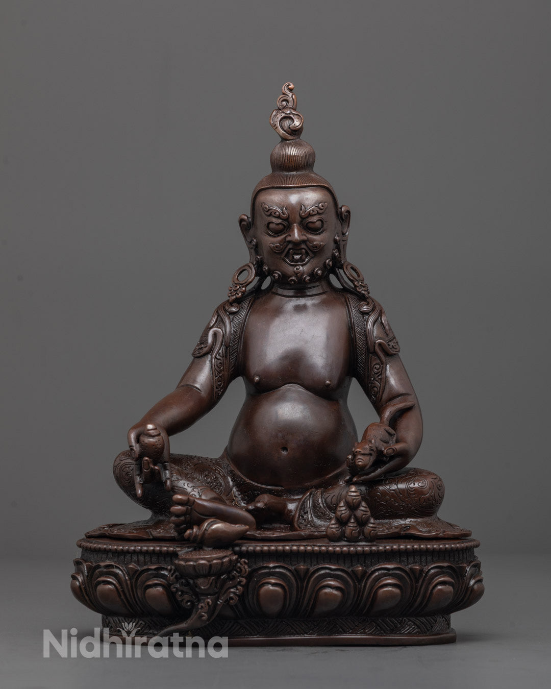 Front view of Oxidized Jambhala Statue with gold-gilded face and citron fruit in hand