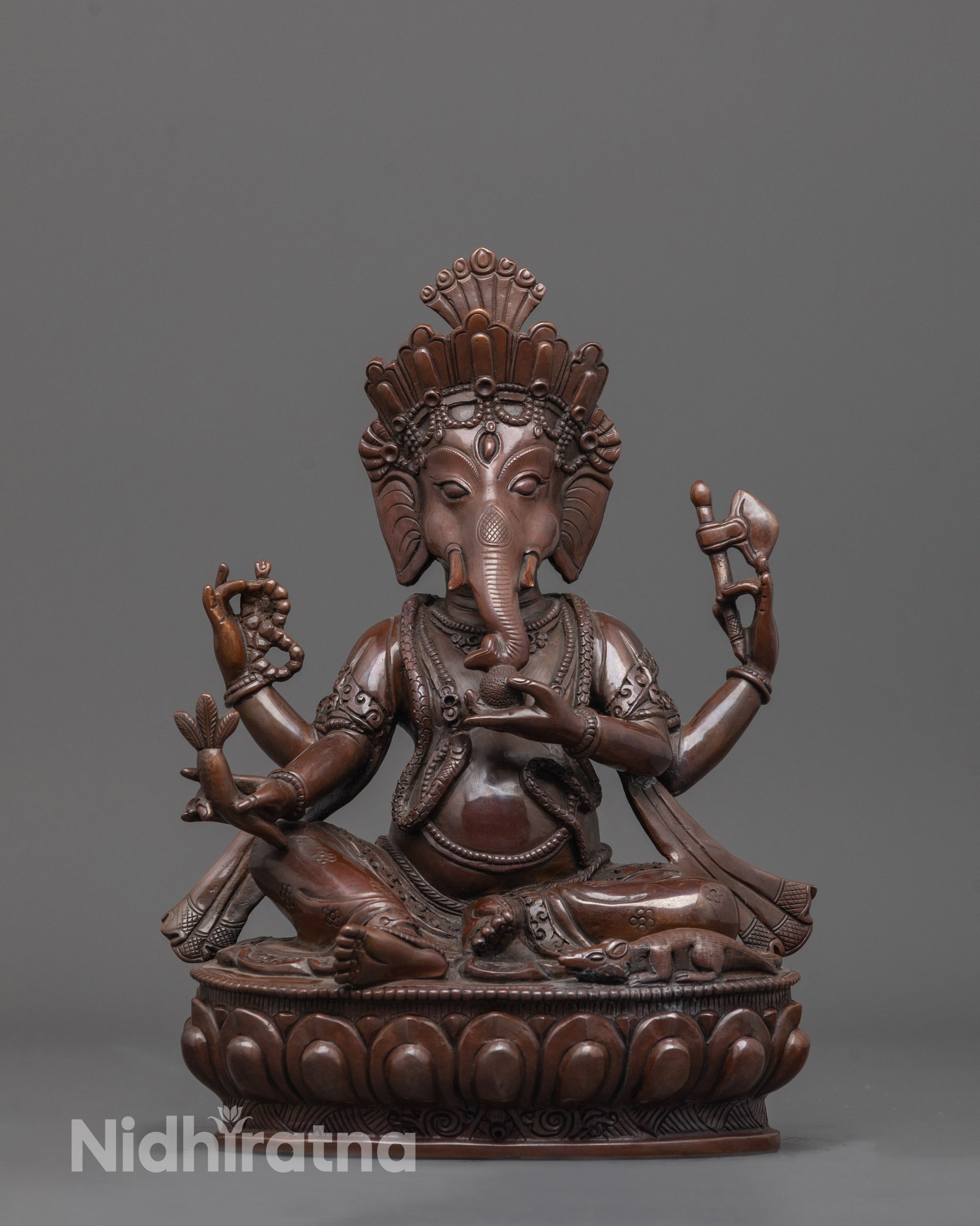 Front view of Oxidized Lord Ganesha Statue showing seated pose on lotus with sacred items.
