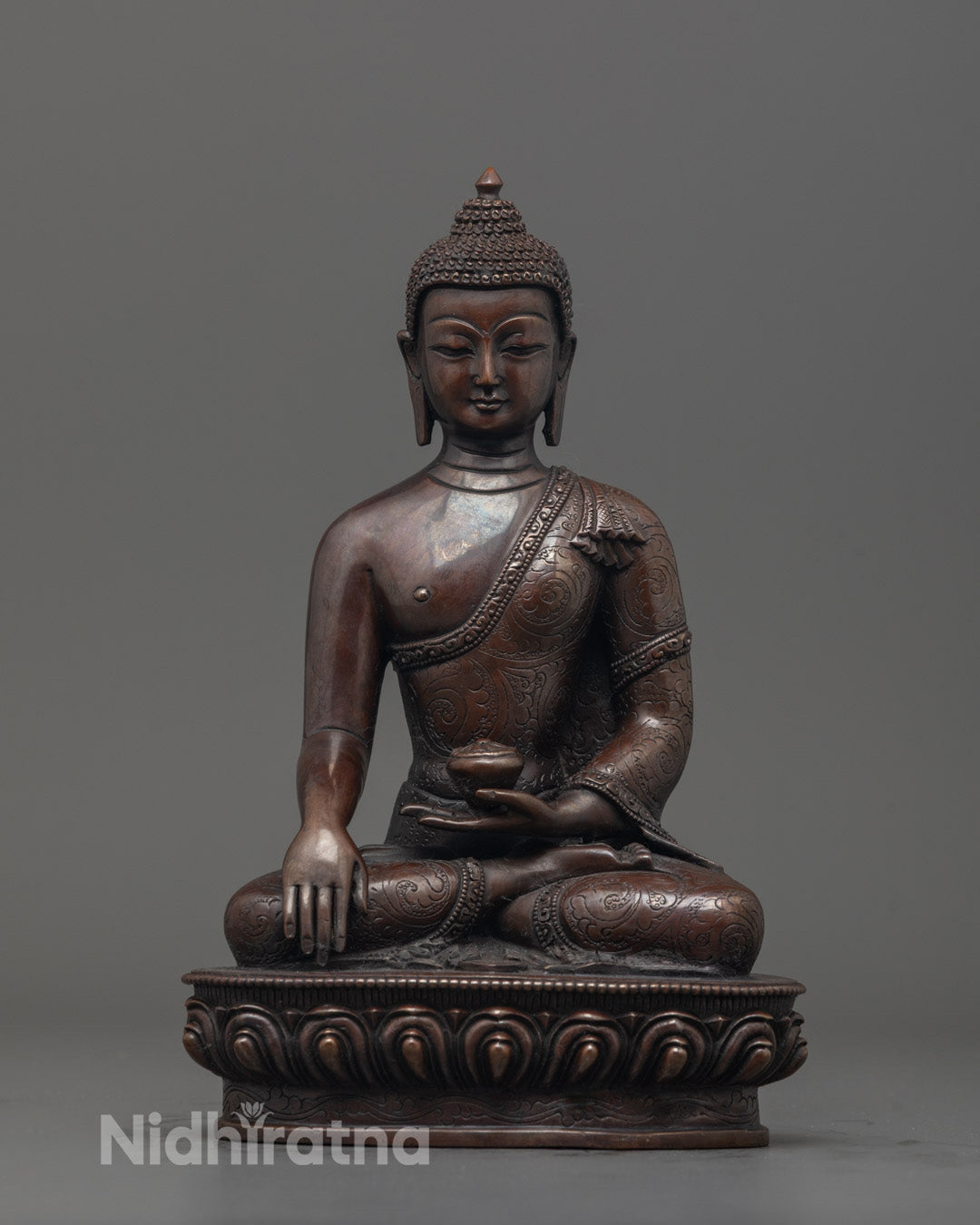 Front view of Oxidized Shakyamuni Buddha Figurine with alms bowl and detailed carvings