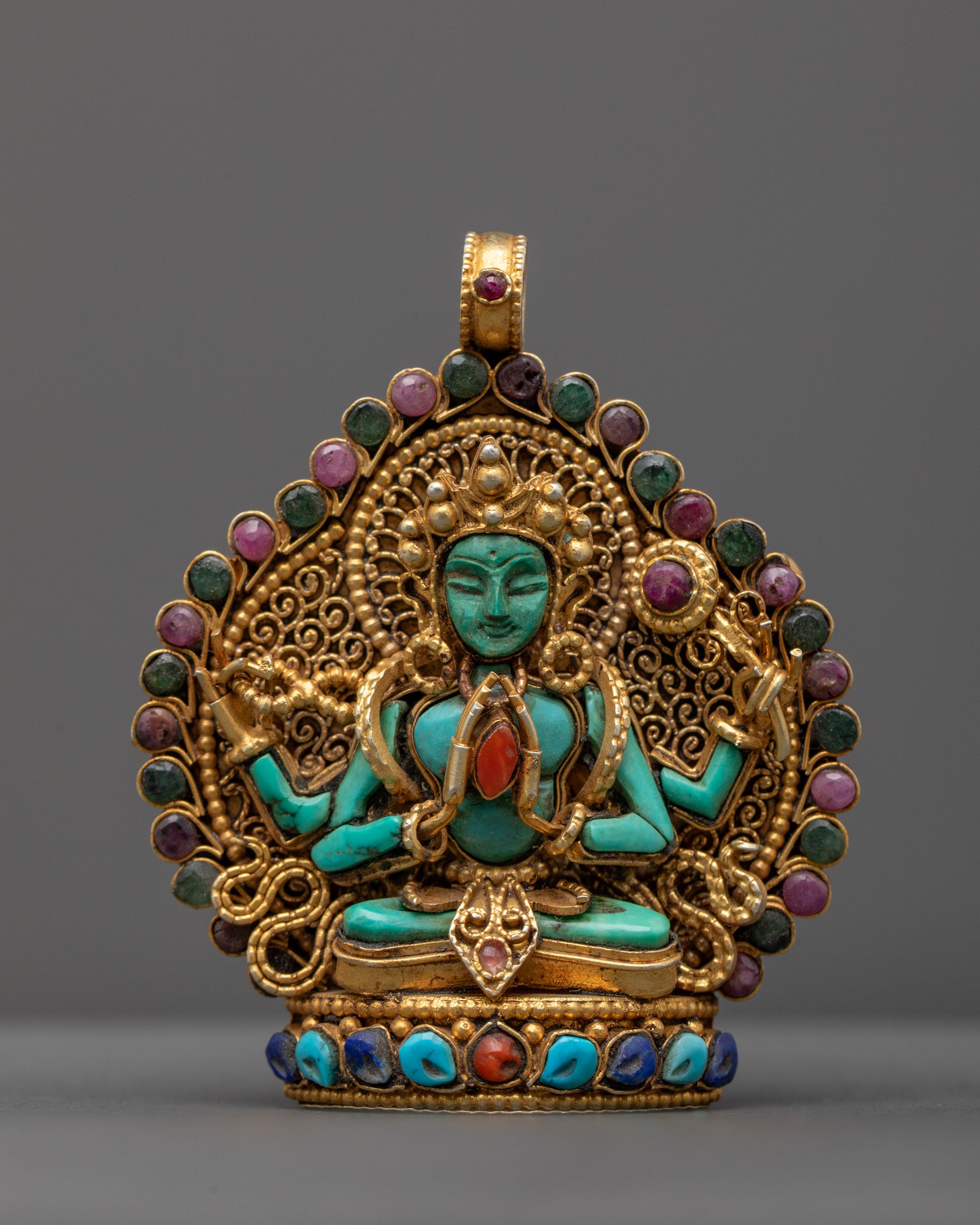 Front view of Sacred Chenrezig Locket with green crystal Chenrezig holding coral gem, gold-gilded filigree, and semi-precious stones.

