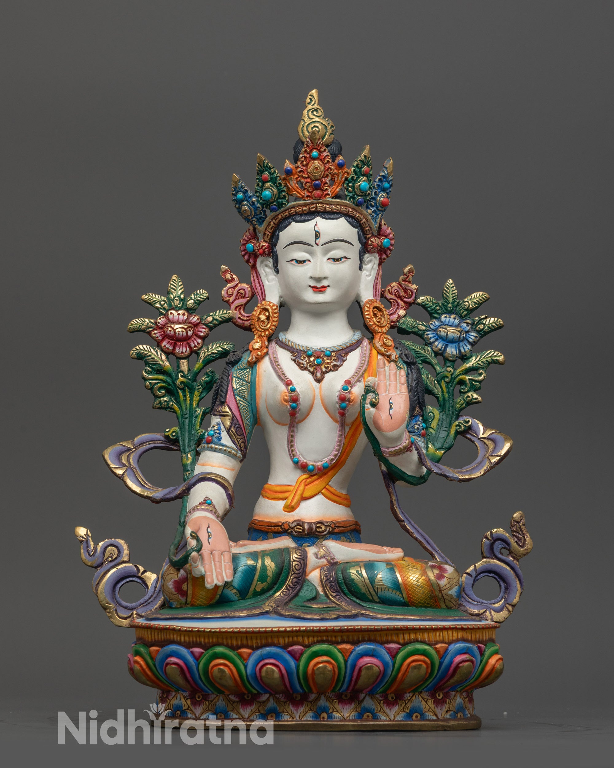 Front view of Seven-Eyed Jetsun Drolma statue showing white body and lotus base