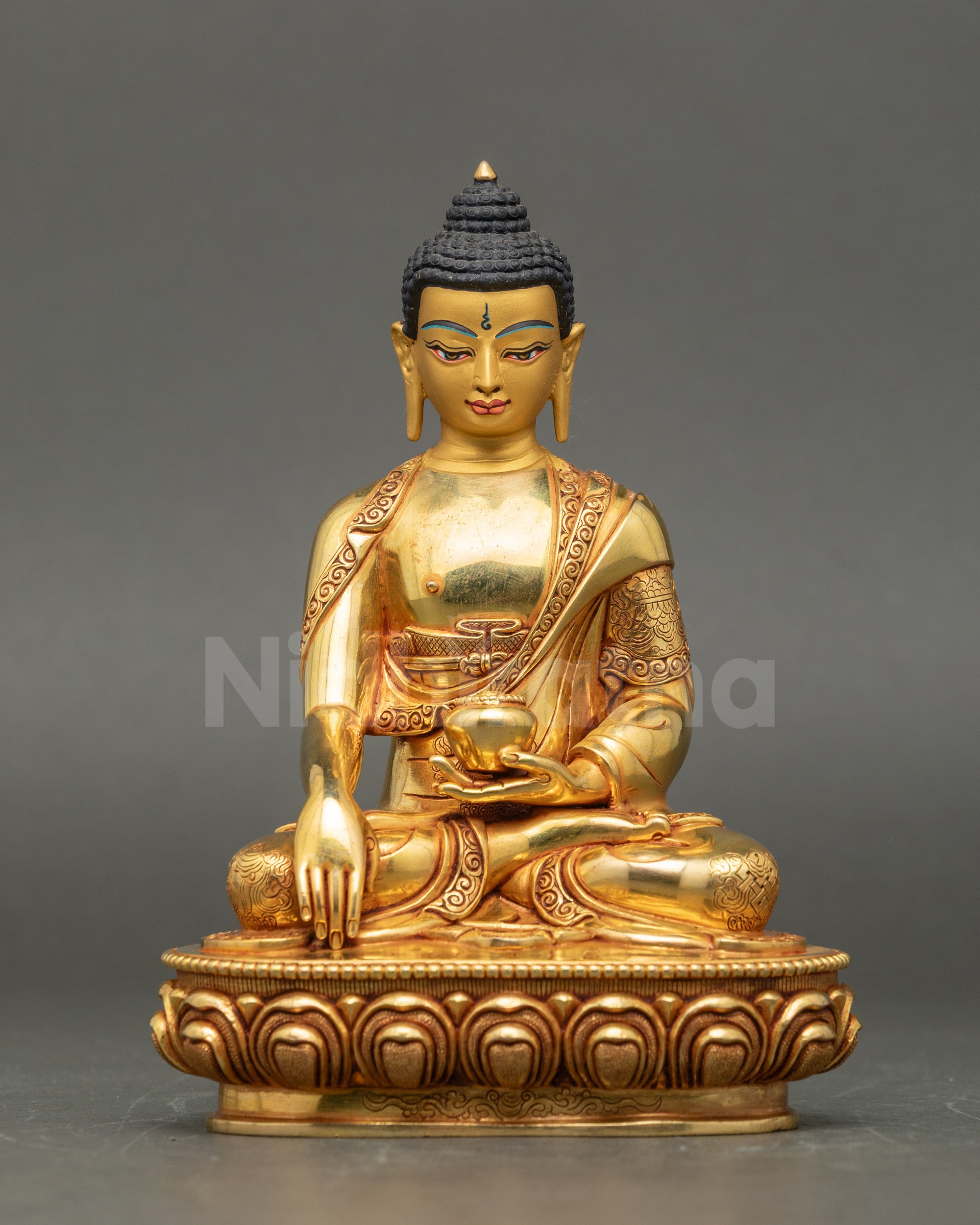 Front view of Shakyamuni Buddha statue, gold fire-gilded copper, seated on lotus