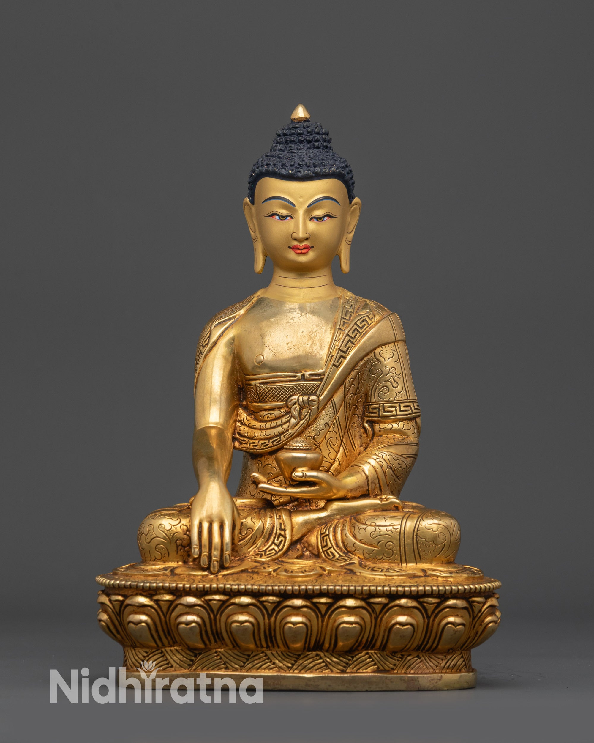 Front view of Shakyamuni Buddha statue on gold-gilded lotus base
