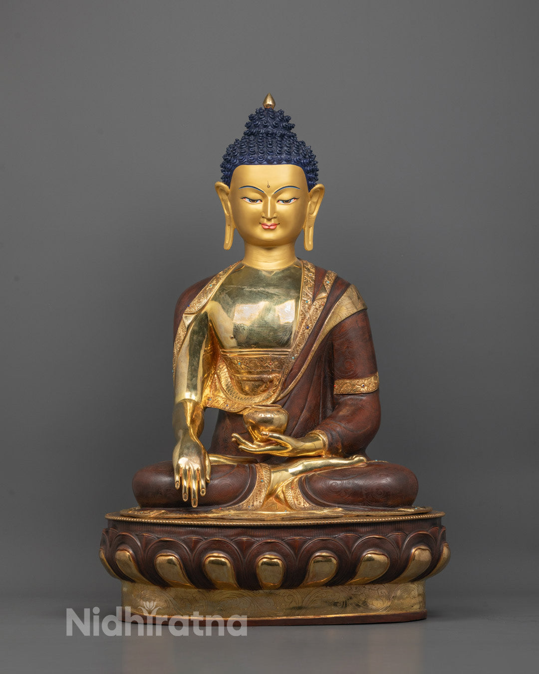 Front view of Shakyamuni Buddha statue with 24K gold-gilded face and intricate carvings
