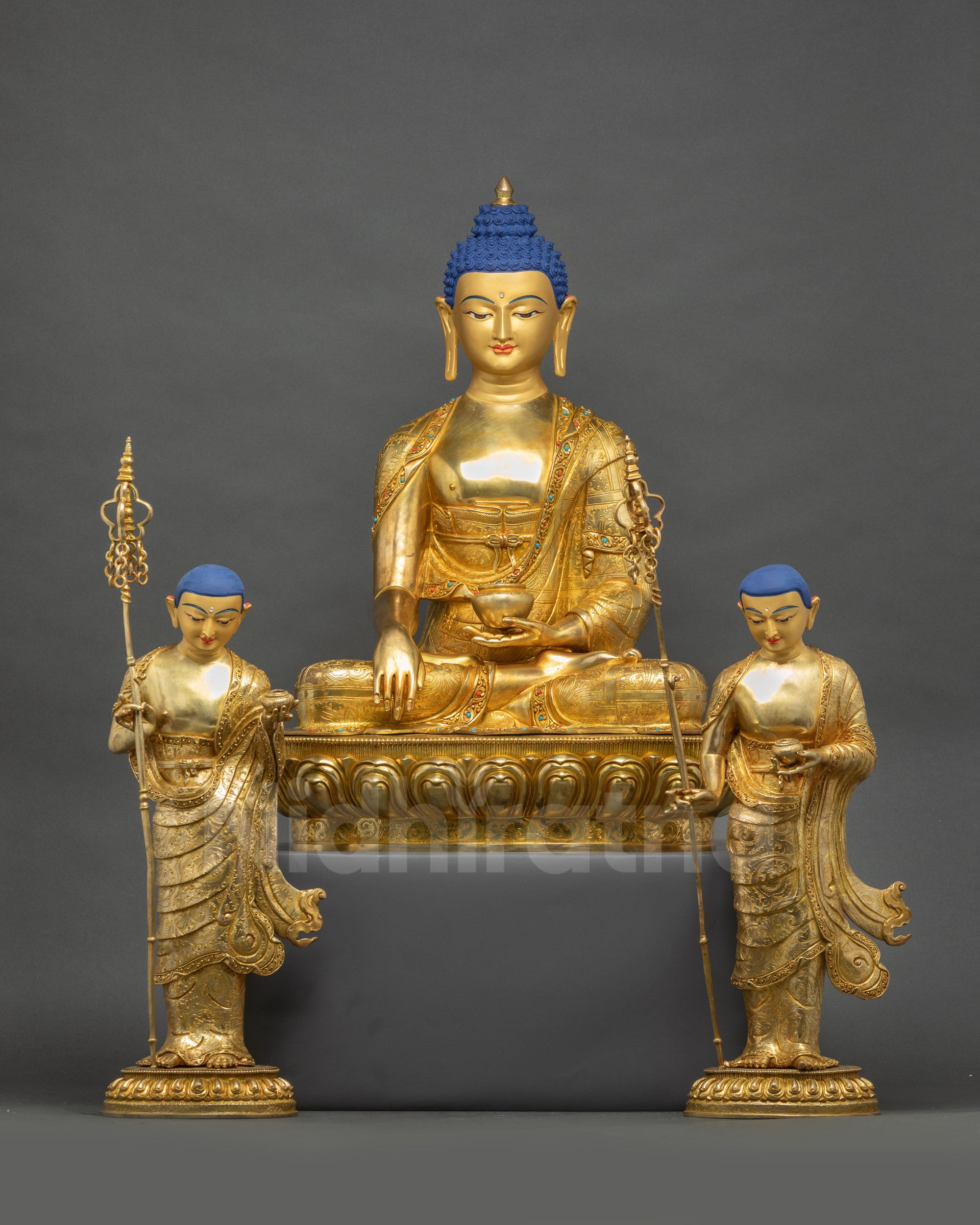 Front view of Shakyamuni Buddha with Disciples Statue on lotus seats with gold faces