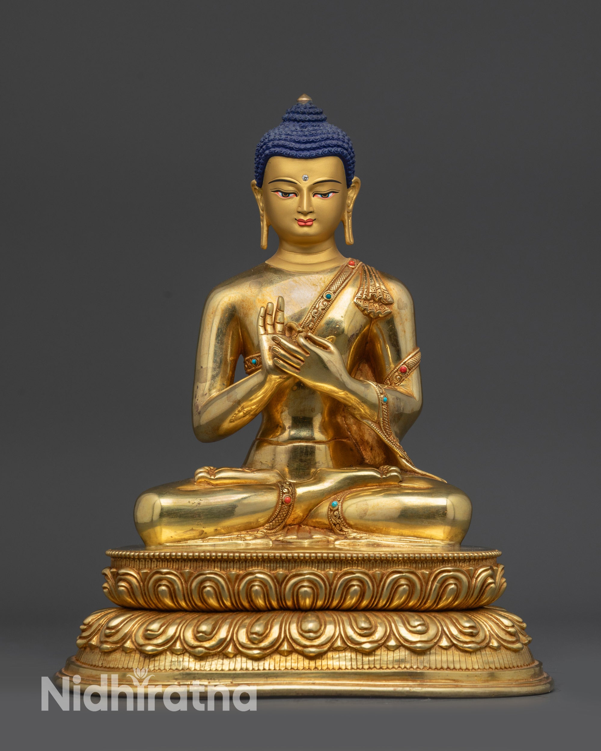 Front view of Suvarnabhadra Vimala Buddha statue on lotus seat in dharmachakra mudra
