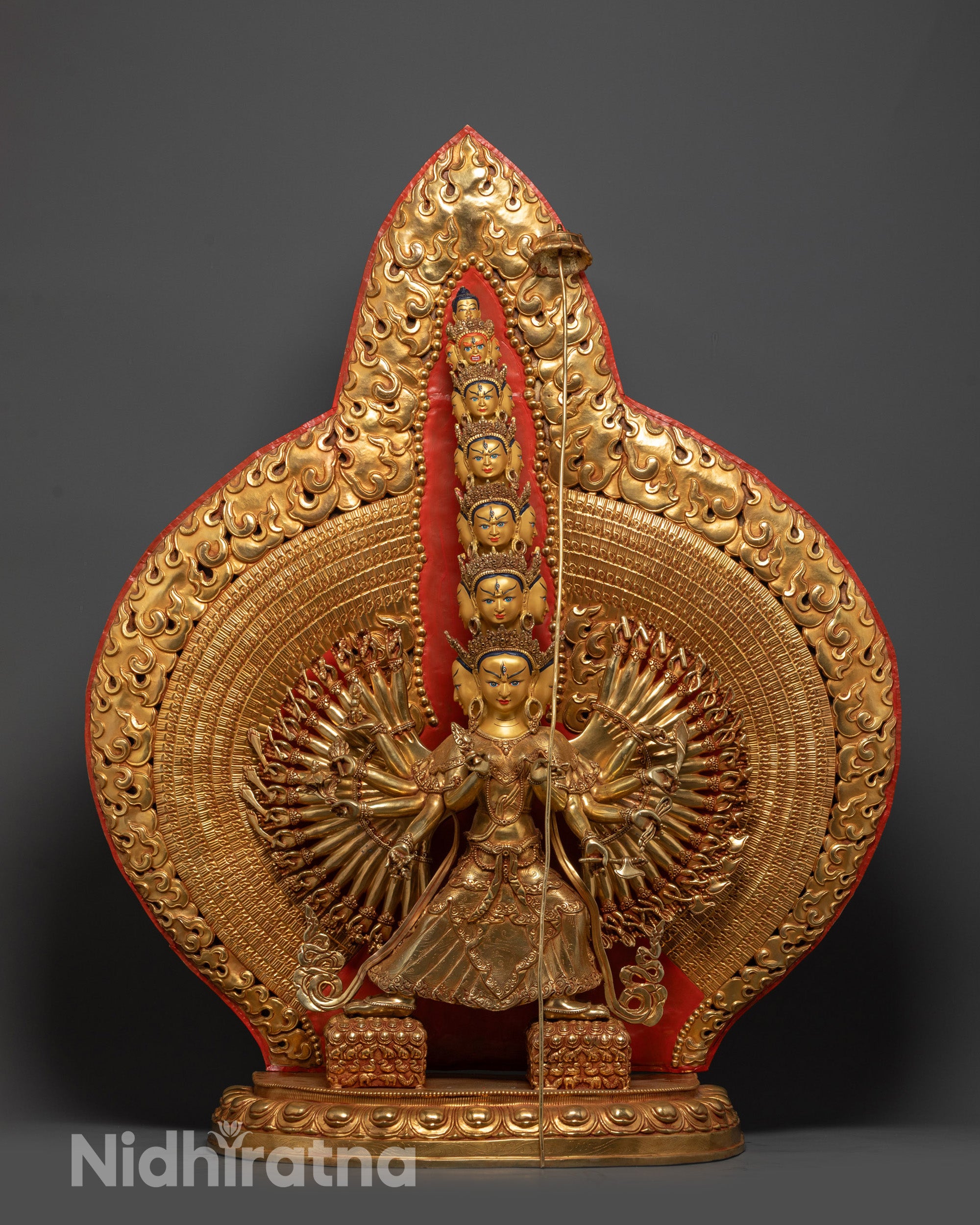 Front view of Thousand-Arm Dukar Statue with gold-gilded face and fire-gilded body
