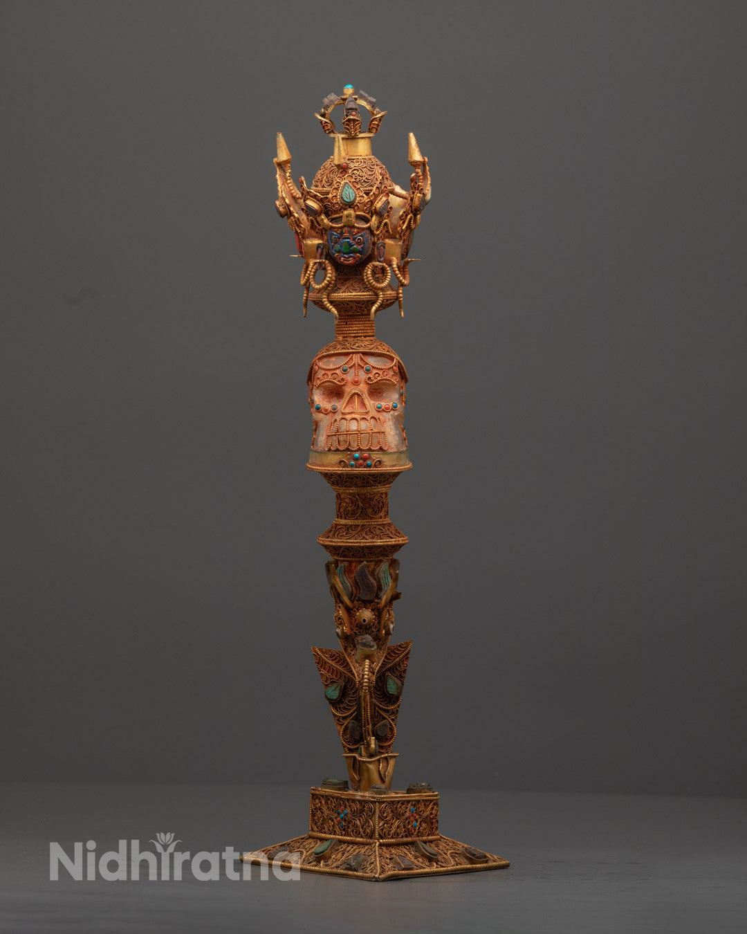 Front view of Tibetan Crystal Phurba with copper details and semi-precious stone inlays