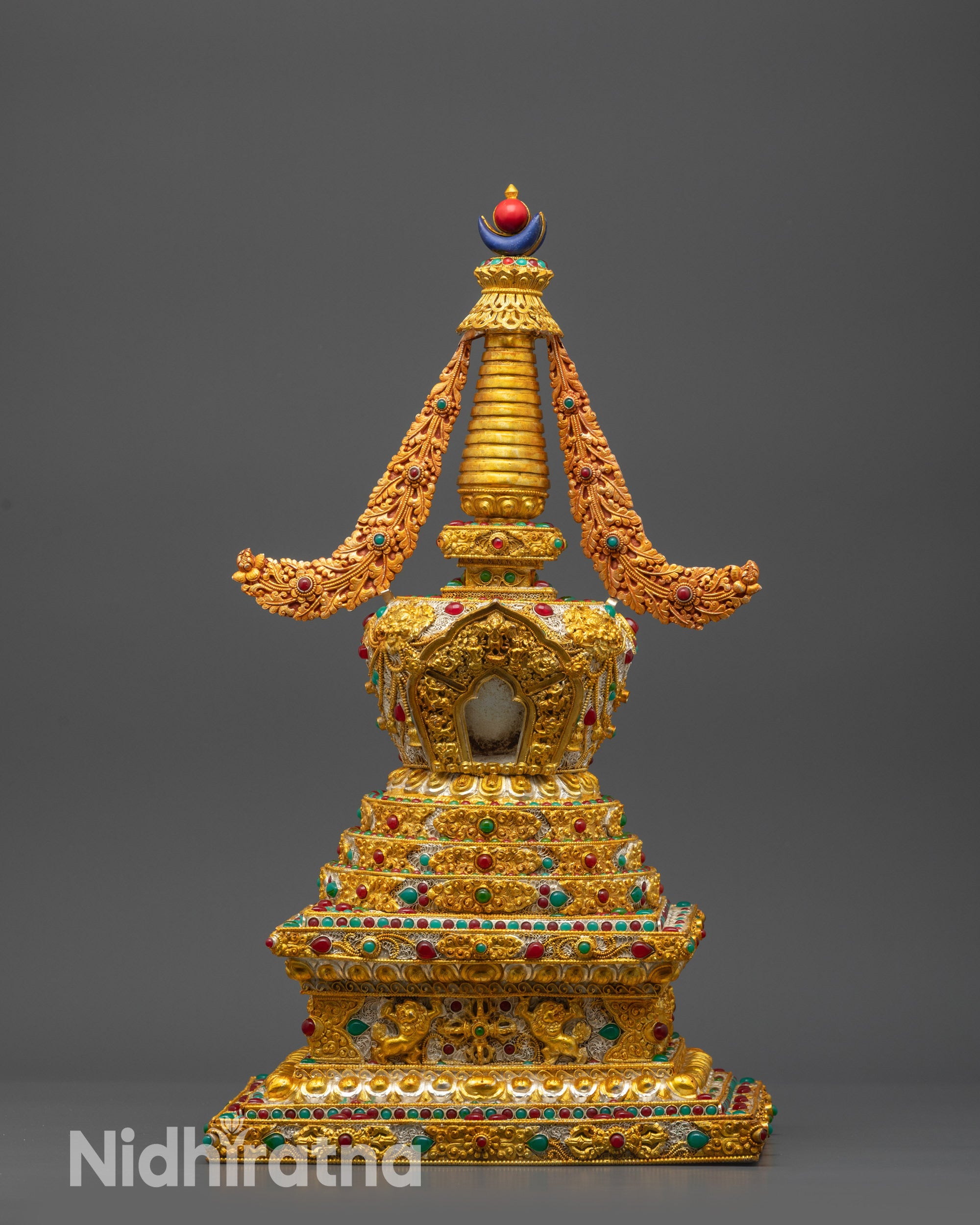 Front view of Tibetan Golden Stupa with copper base and gold-plated filigree designs
