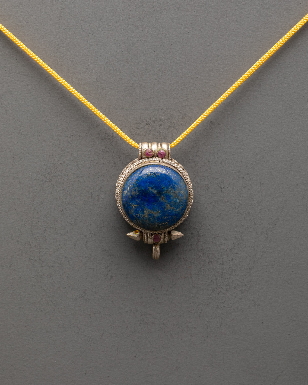 Front view of Tibetan Lapis Lazuli Pendant with intricate silver design and blue stone