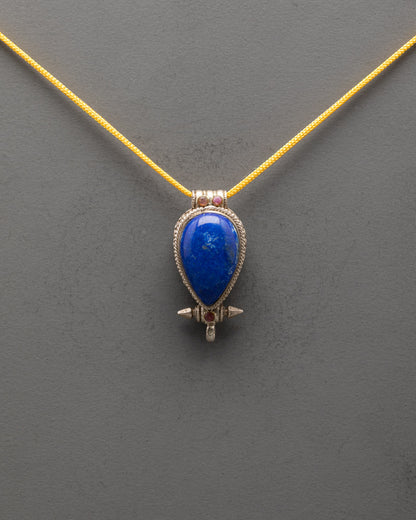 Front view of Tibetan Lapis Lazuli locket with coral accents and intricate silver design

