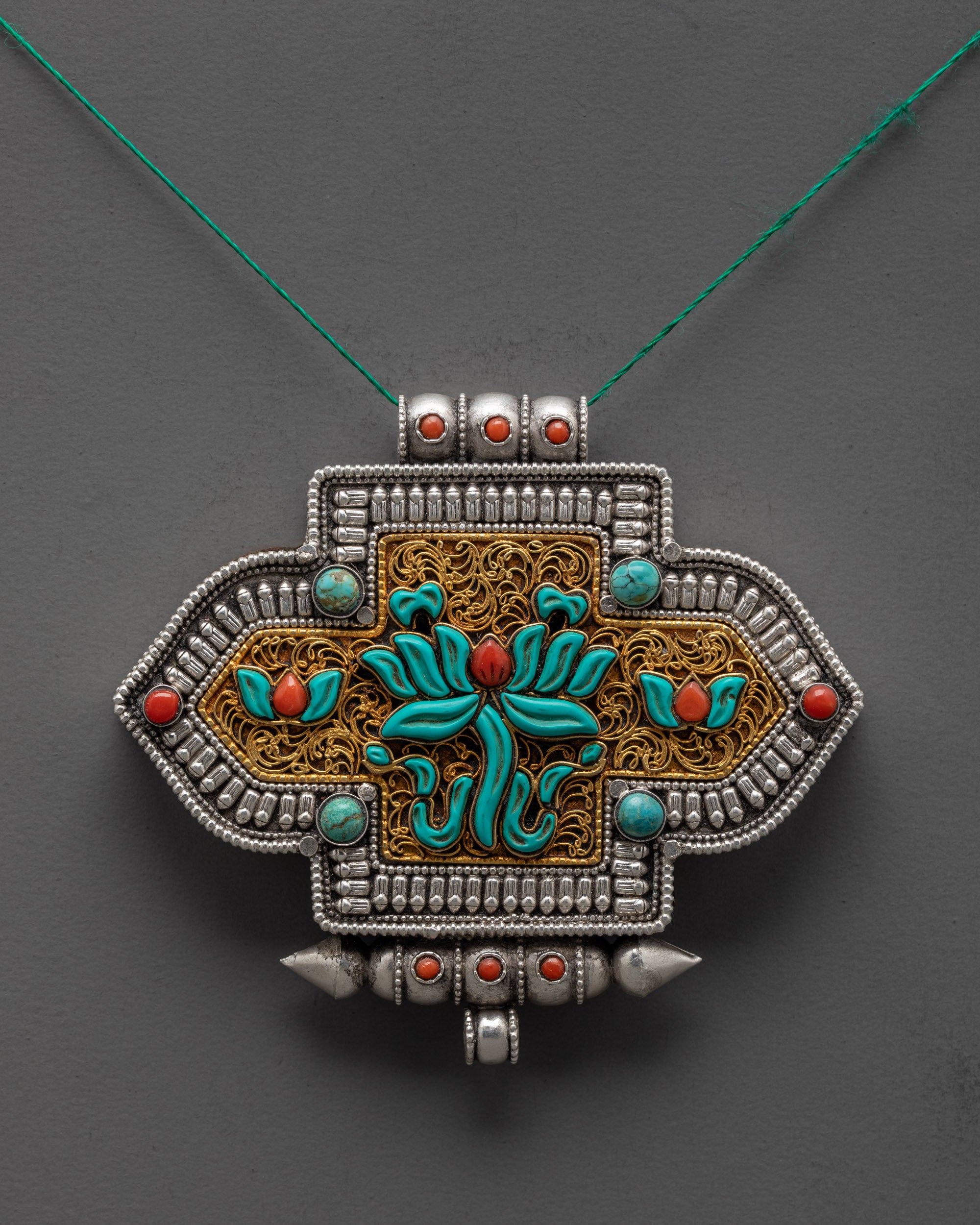Front view of Tibetan Lotus Locket pendant with silver body and coral turquoise stones
