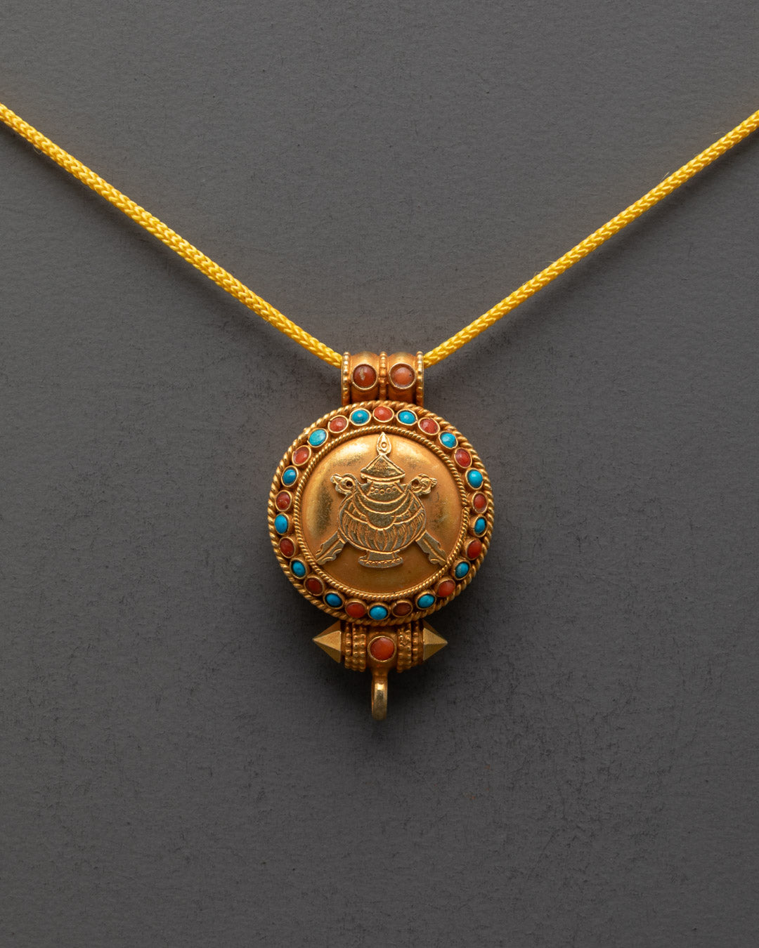 Front view of Tibetan Treasure Vase Locket with gold-gilded body and semi-precious stones
