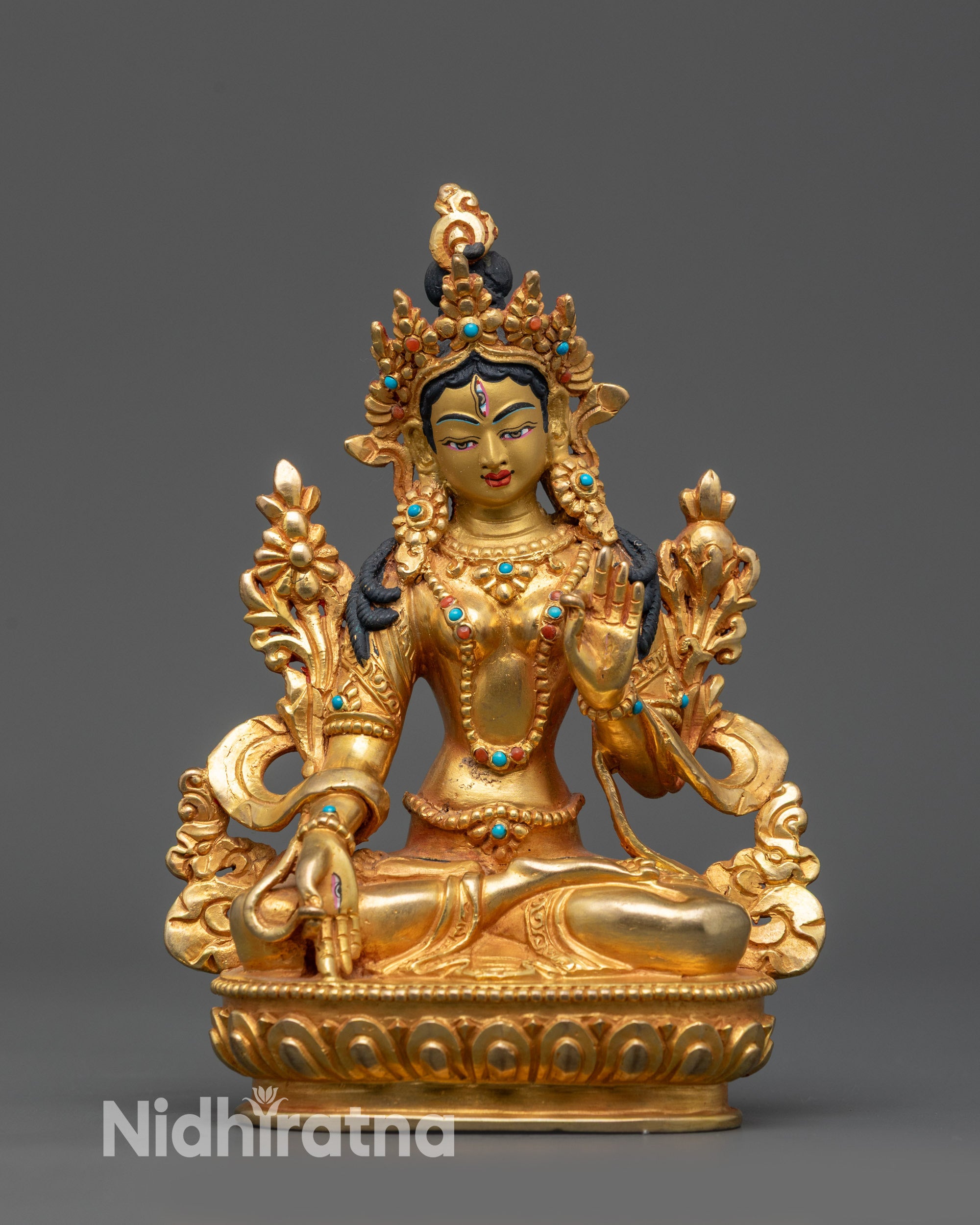 Front view of Tibetan White Tara statue with lotus posture and 24K gold-gilded face
