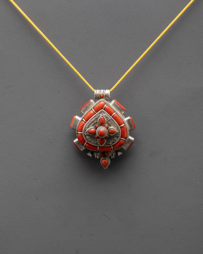Front view of Traditional Coral Locket with silver body and intricate filigree design