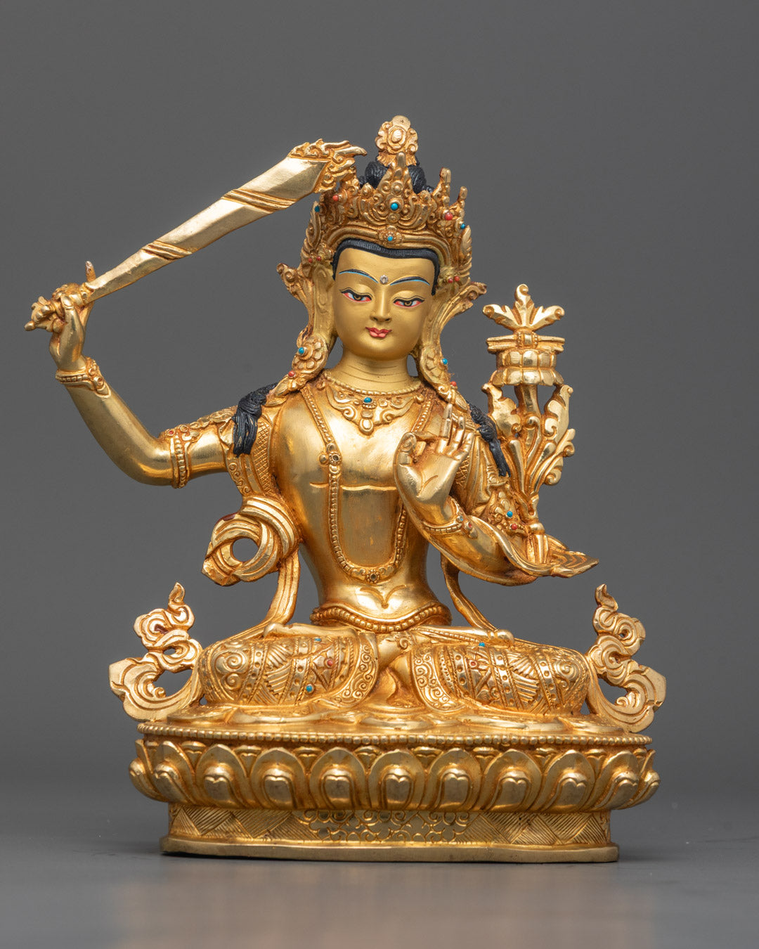 Front view of Traditional Manjushri Statue with gold-gilded face and wisdom sword